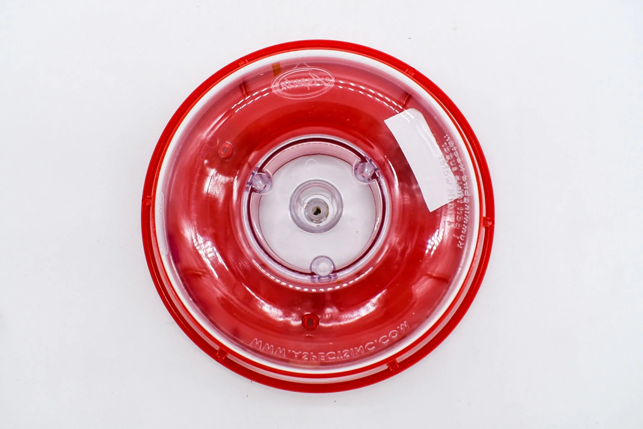 Underside of the red HighView Mini feeder cover showing three raised flower feeding ports.
