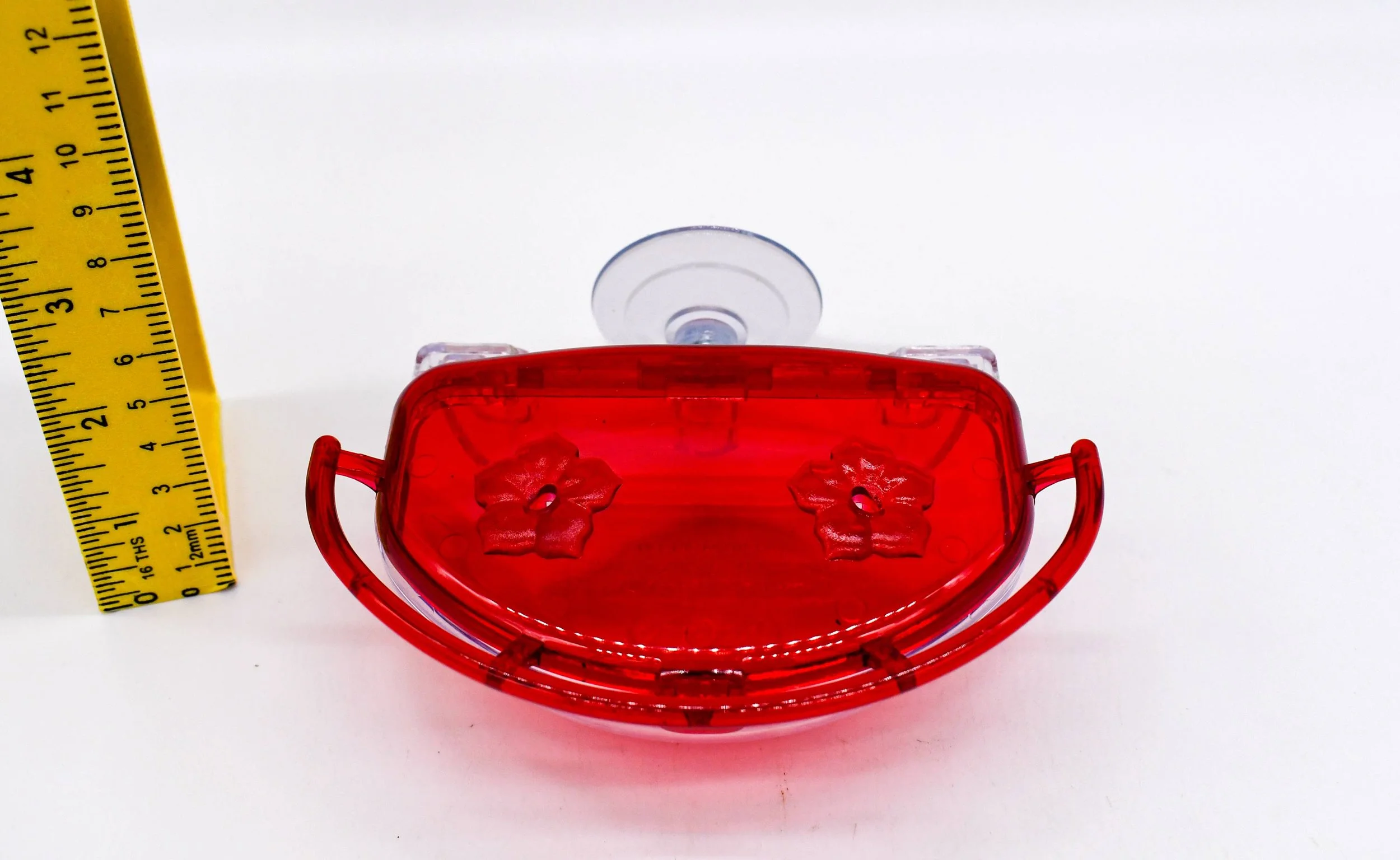Front close-up of the Aspects The Gem 4 oz Window Hummingbird Feeder highlighting the dual flower feeding ports, perch, and suction cup mounting system.