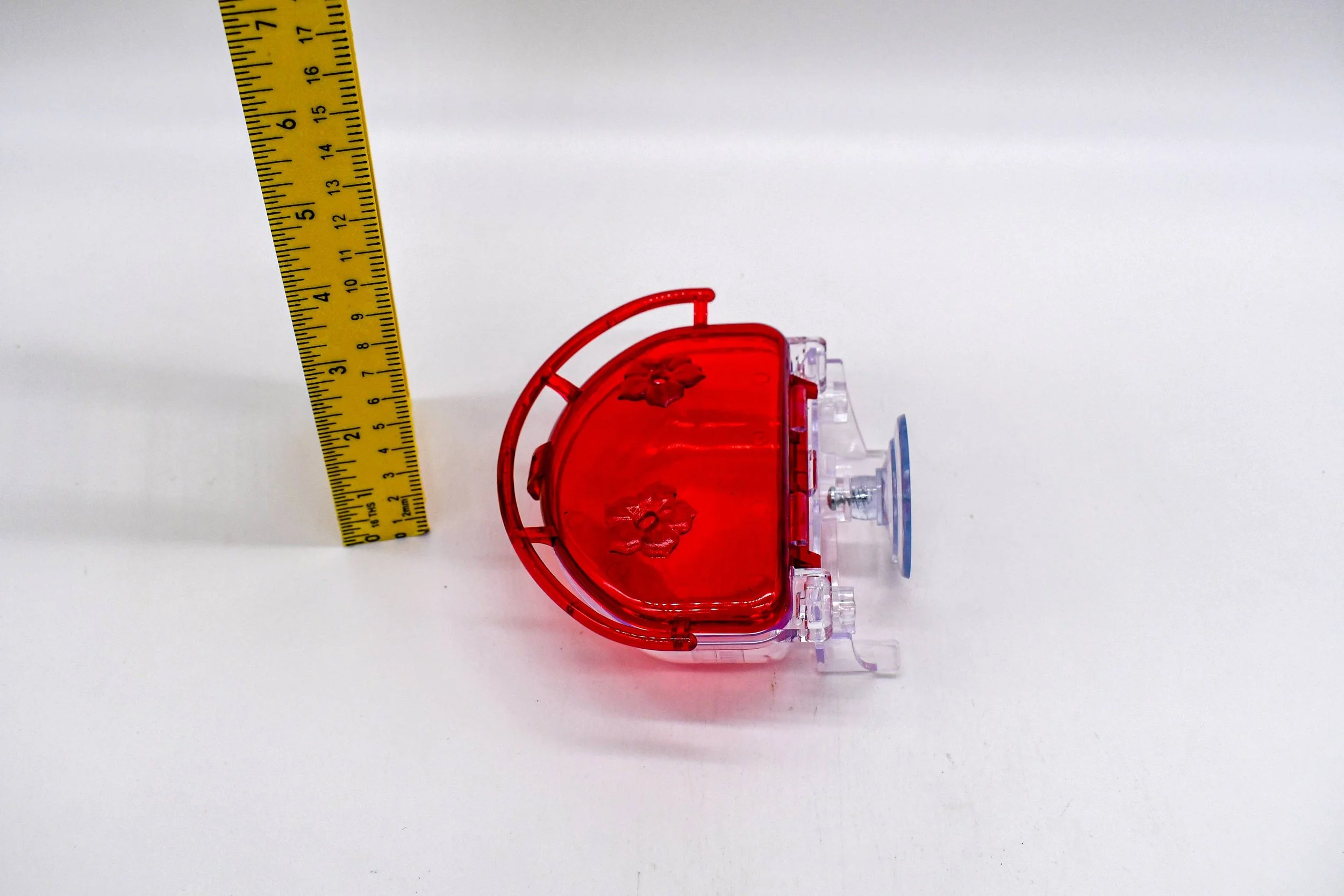 Top view of the Aspects The Gem 4 oz Window Hummingbird Feeder with the lid open, highlighting the dual feeding ports, hinged cover, and compact window-mounted design.
