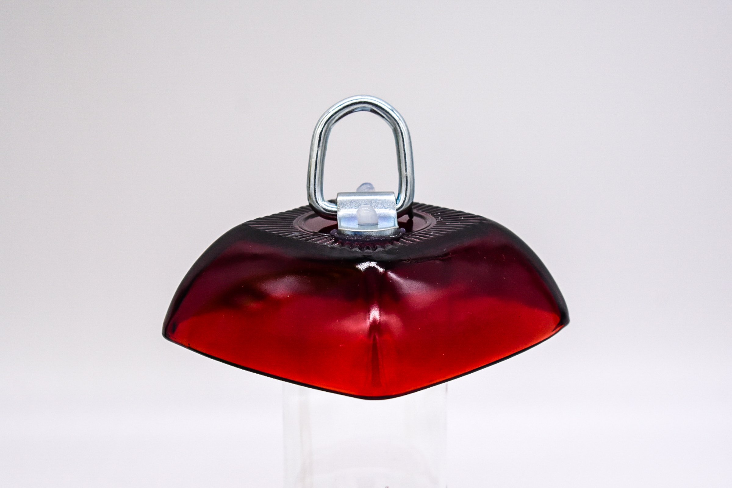 Tilted Side view of the Anchor Hocking Ruby Red Berry Bowl glass with D Ring mounted on top.
