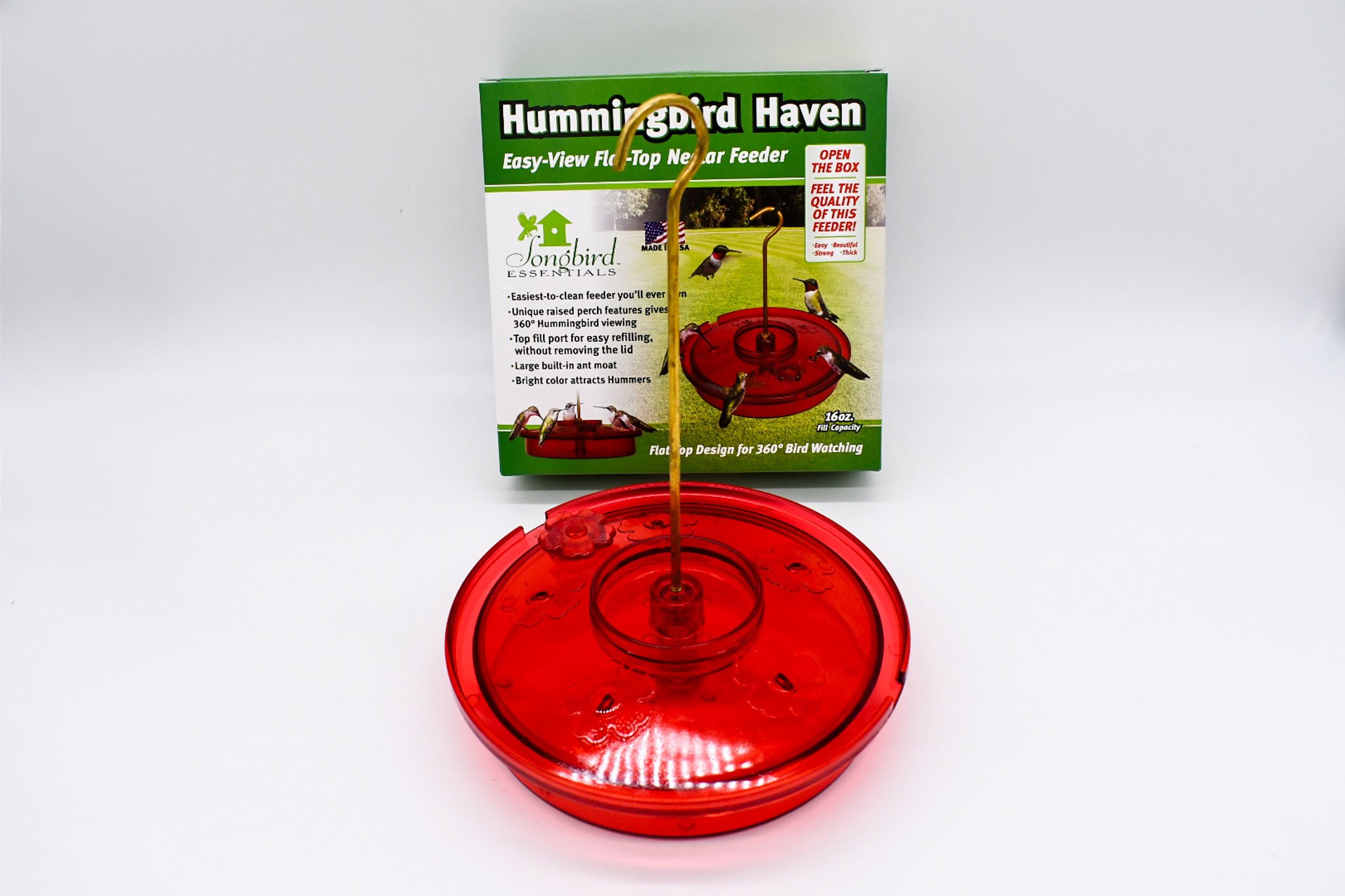Assembled Songbird Essentials Hummingbird Haven feeder displayed with its retail packaging.