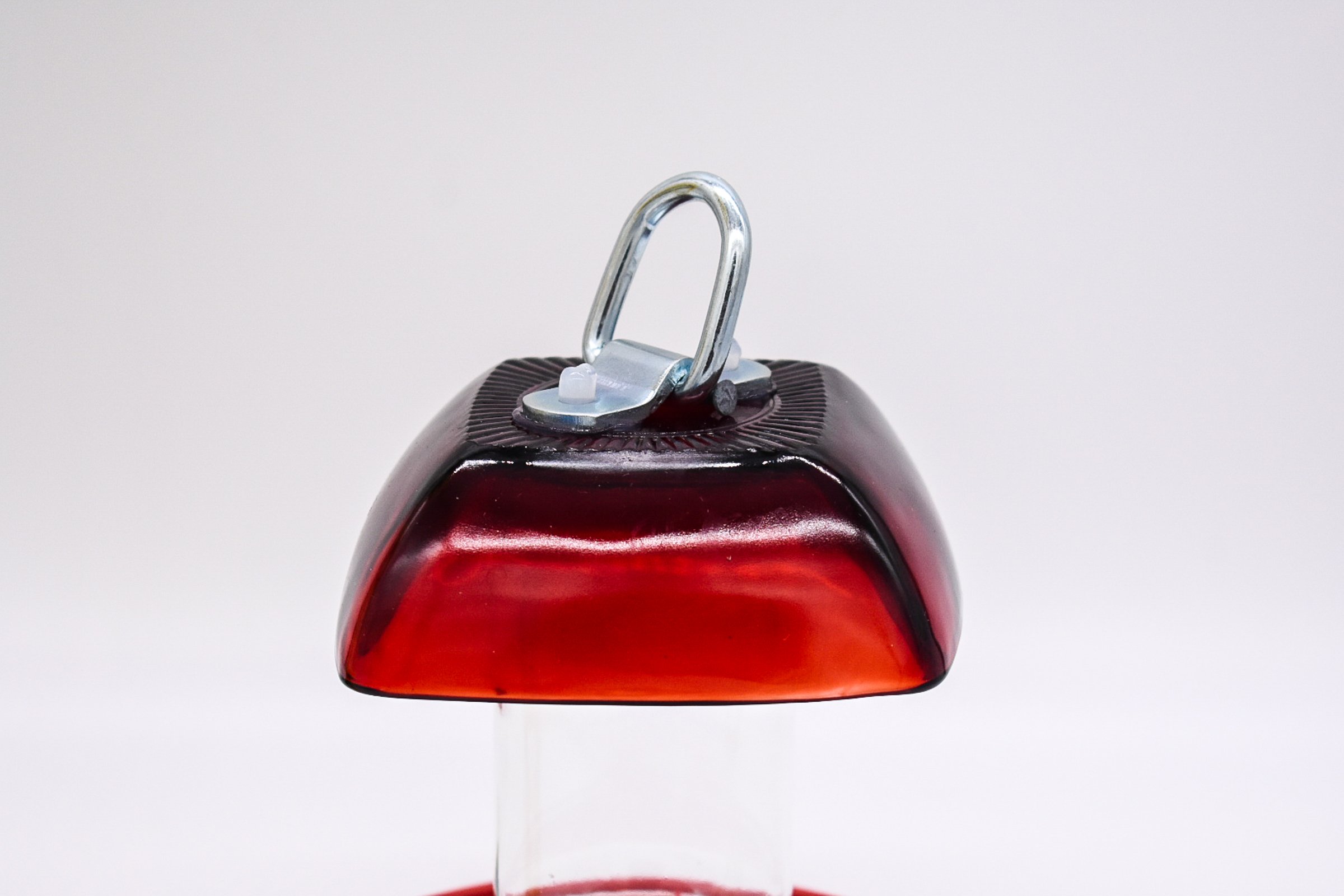 Side view of the Anchor Hocking Ruby Red Berry Bowl glass with D Ring mounted on top.
