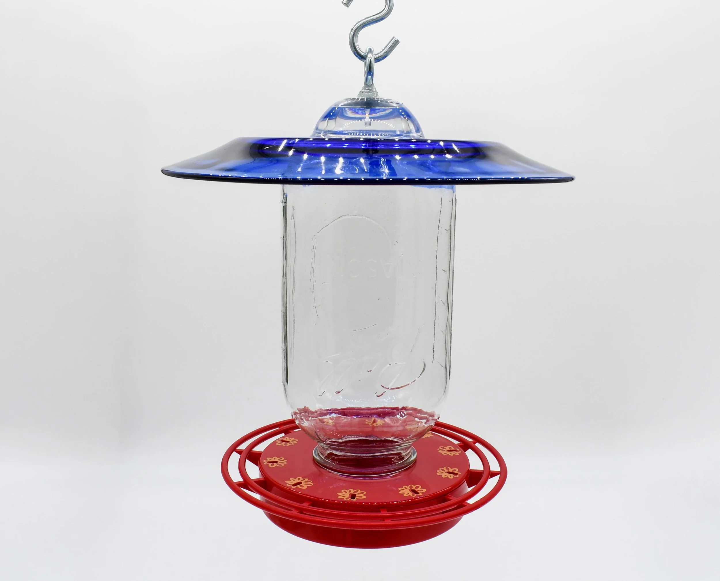 Close-up of the 64 oz Mason jar reservoir and red Turbine hummingbird feeder base showing hanging on "S" Hook.
