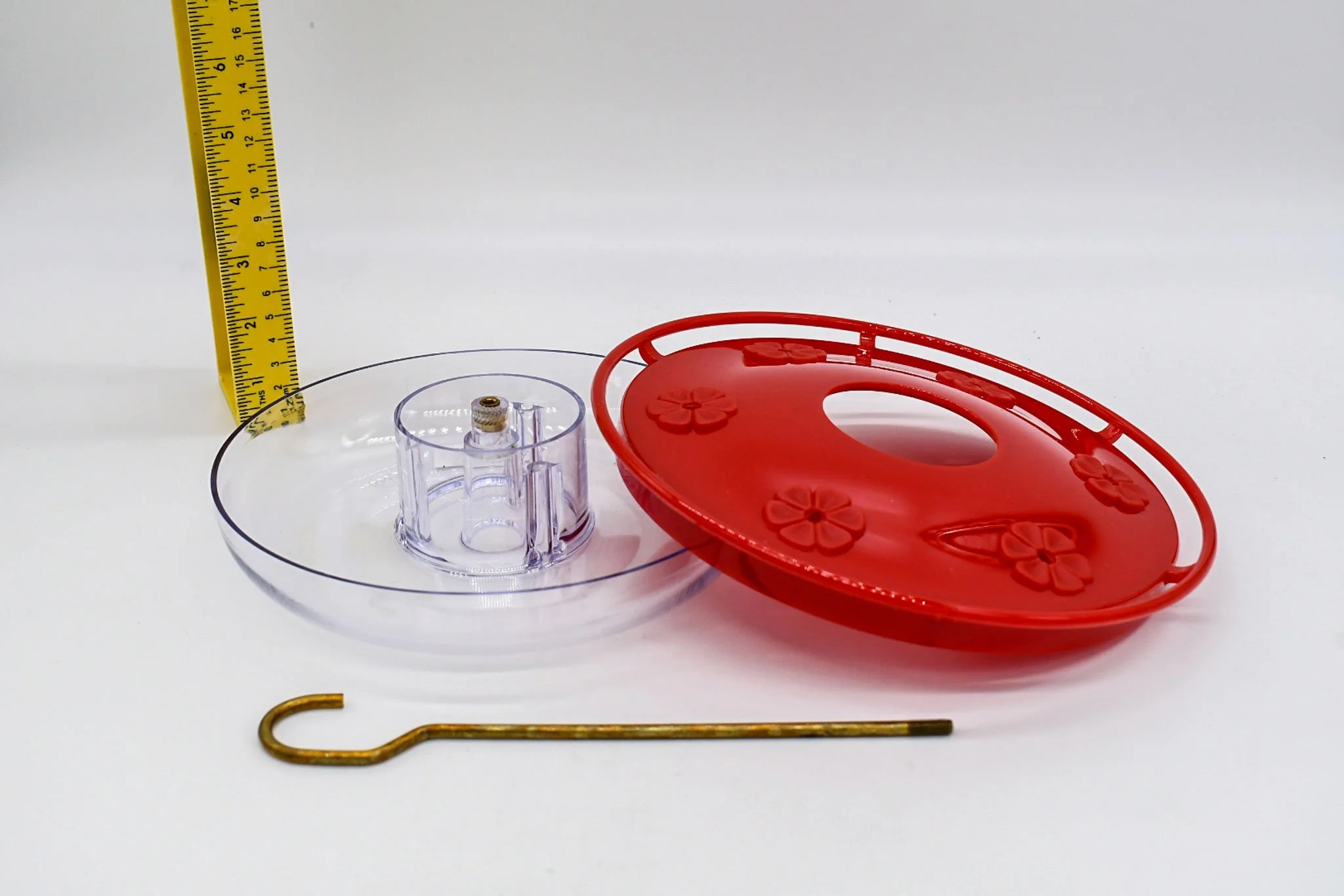 Clear feeder basin, red cover and brass hanging hook separated to show the HighView Excel two-piece construction.