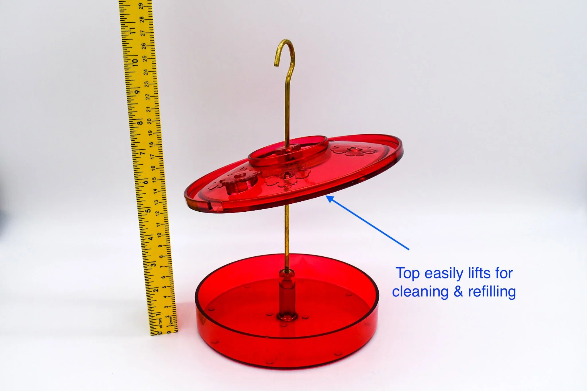 Top view of the red Hummingbird Haven feeder with its removable top-fill cap displayed separately.