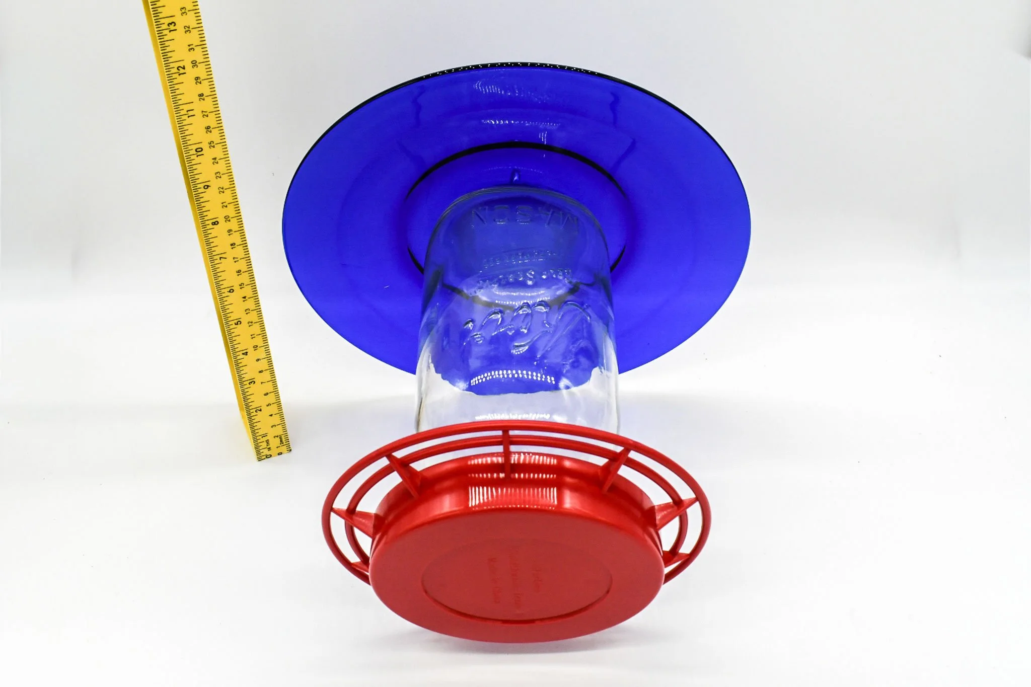 Side view showing the height and profile of the 64 oz cobalt glass hummingbird feeder.