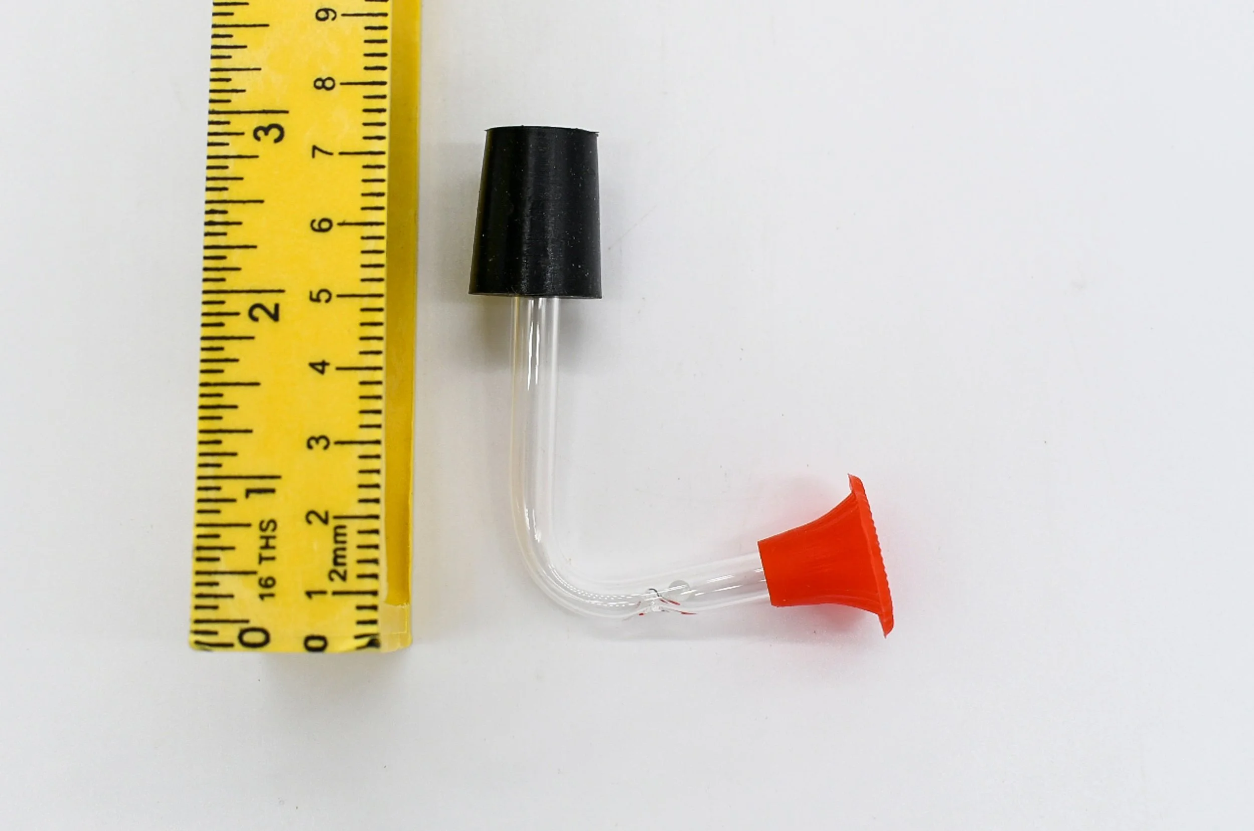 Hummingbird feeder replacement stopper and feeding tube shown with ruler for length measurement