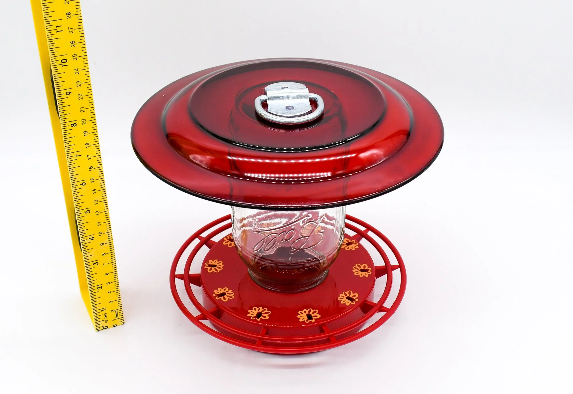 Vintage-inspired Ruby Red glass hummingbird feeder, made with a 32 oz mason jar reservoir and a 10-port bee-proof base.