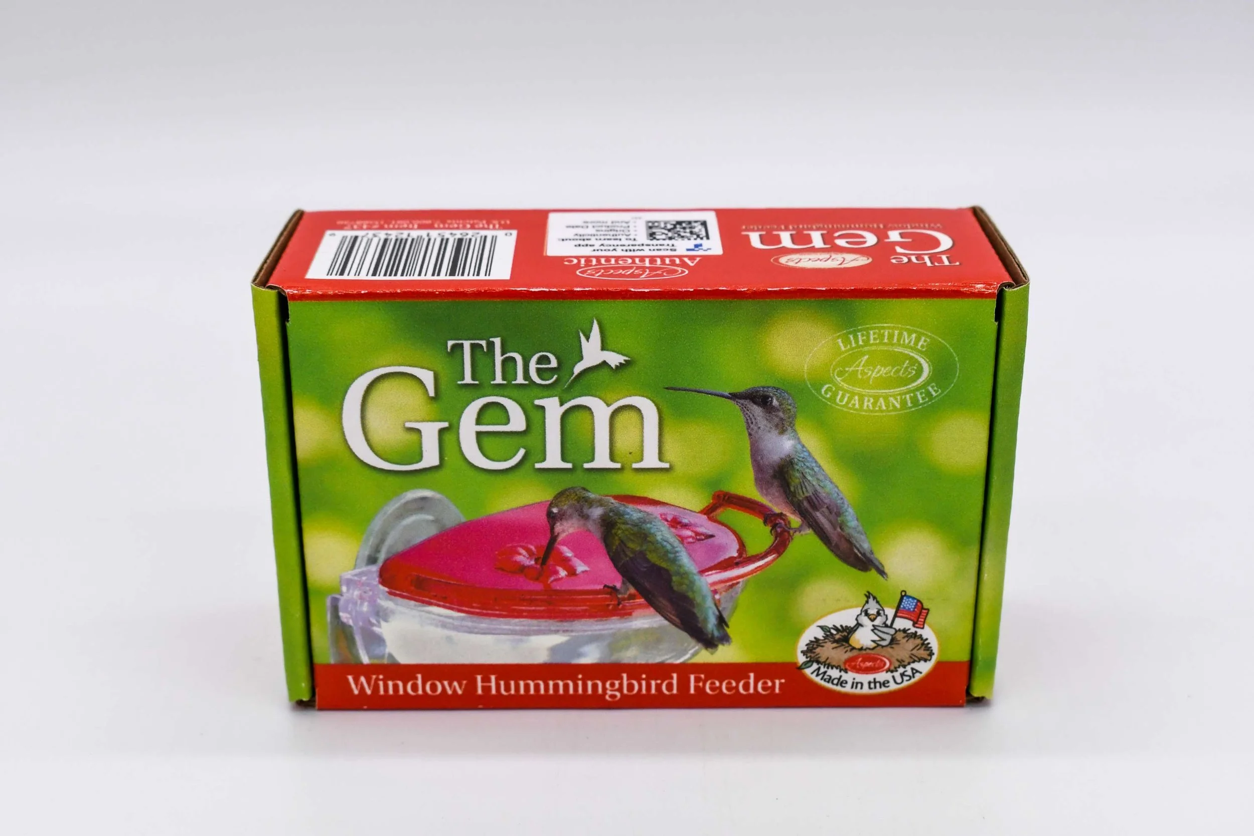 Front view of the retail packaging for the Aspects The Gem 4 oz Window Hummingbird Feeder featuring product branding, Made in USA construction, and lifetime guarantee.