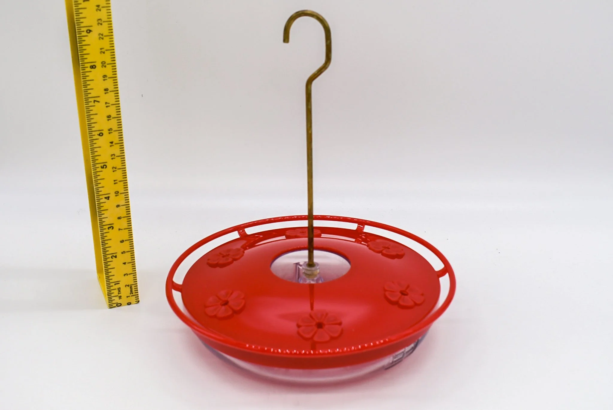 Side profile of the Aspects HighView Excel hummingbird feeder and hanging hook shown beside a measuring tape.