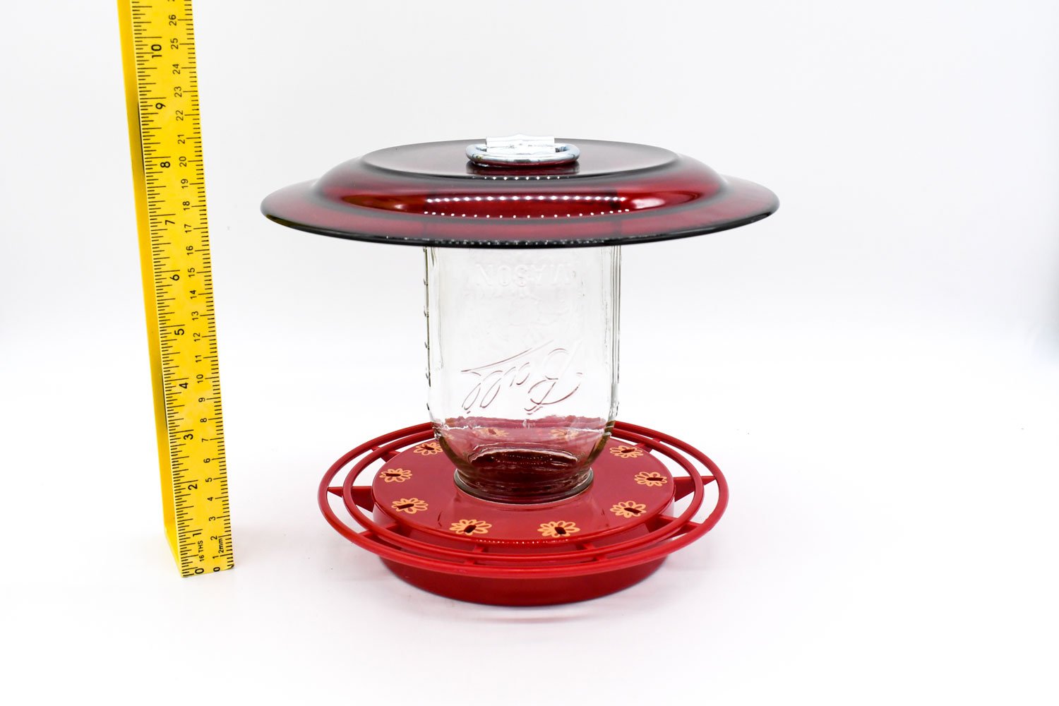 Garden mounted hummingbird feeder with ant moat and red feeding plate