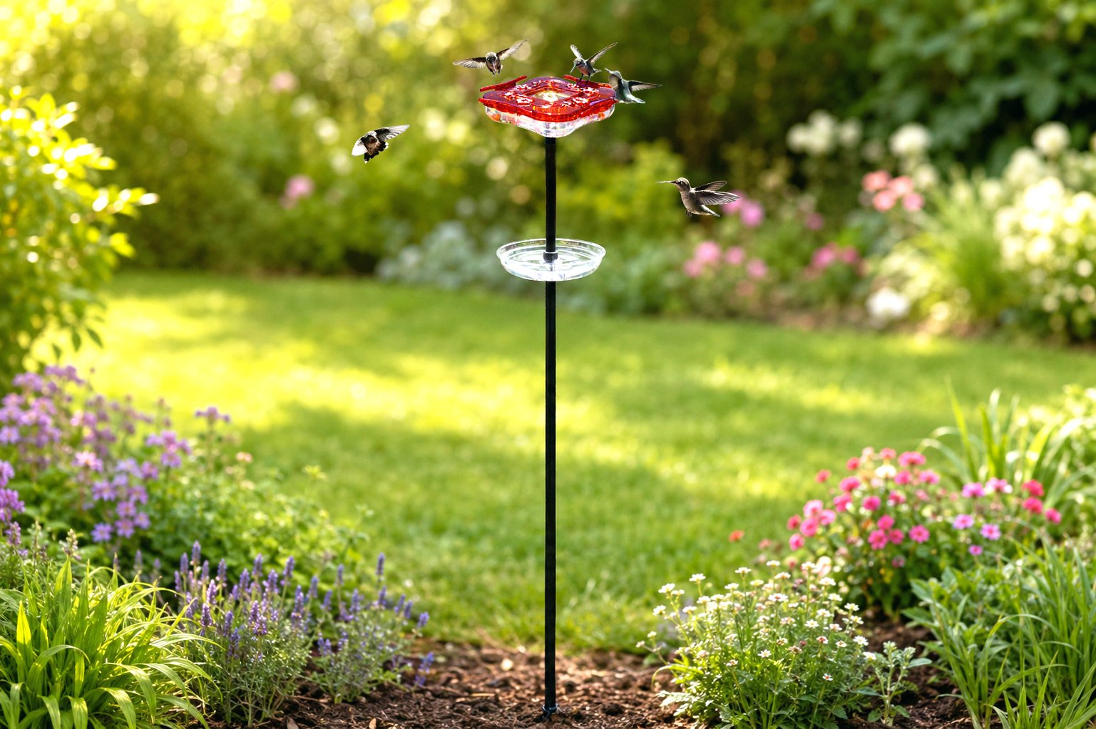 Aspects HighView Square 8 oz hummingbird feeder with ground pole installed in a flower garden