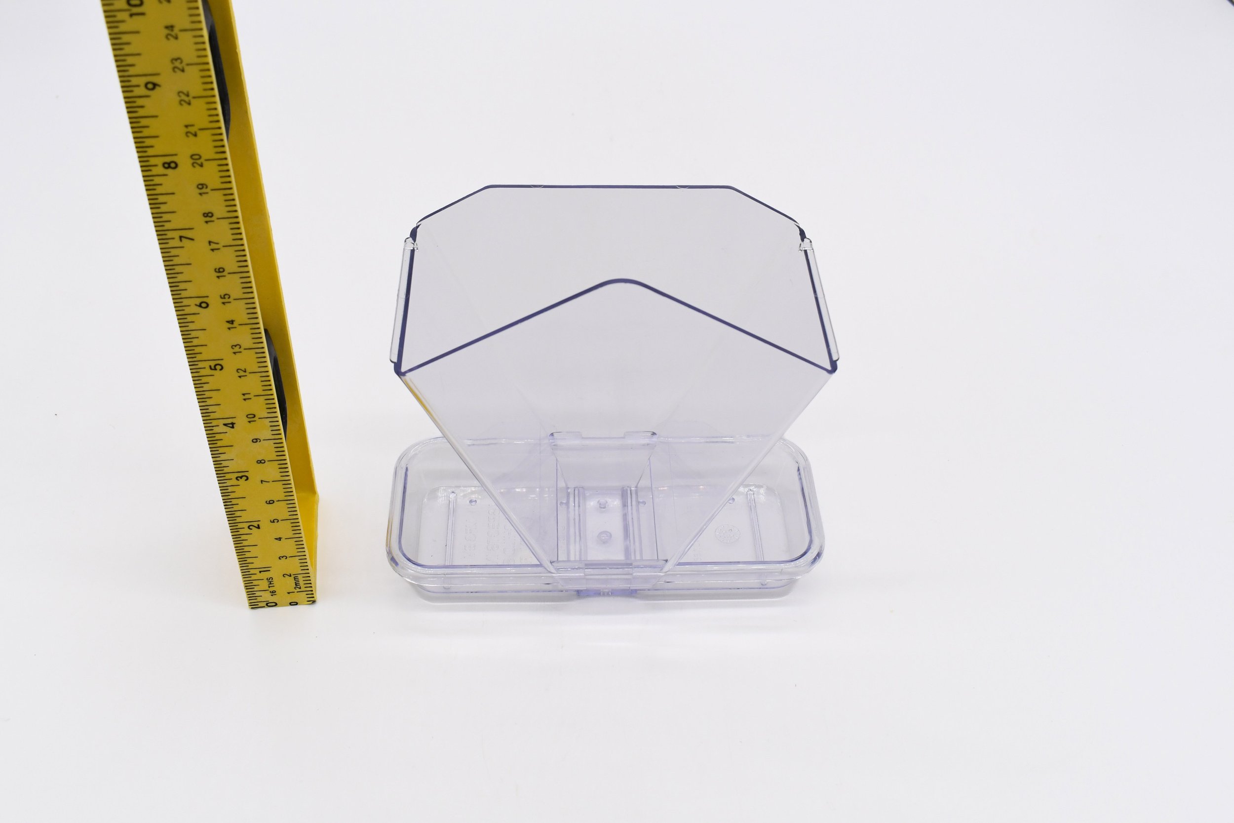Clear polycarbonate roof and feeding tray of the Aspects Window Cafe bird feeder shown with a measuring ruler for size reference.