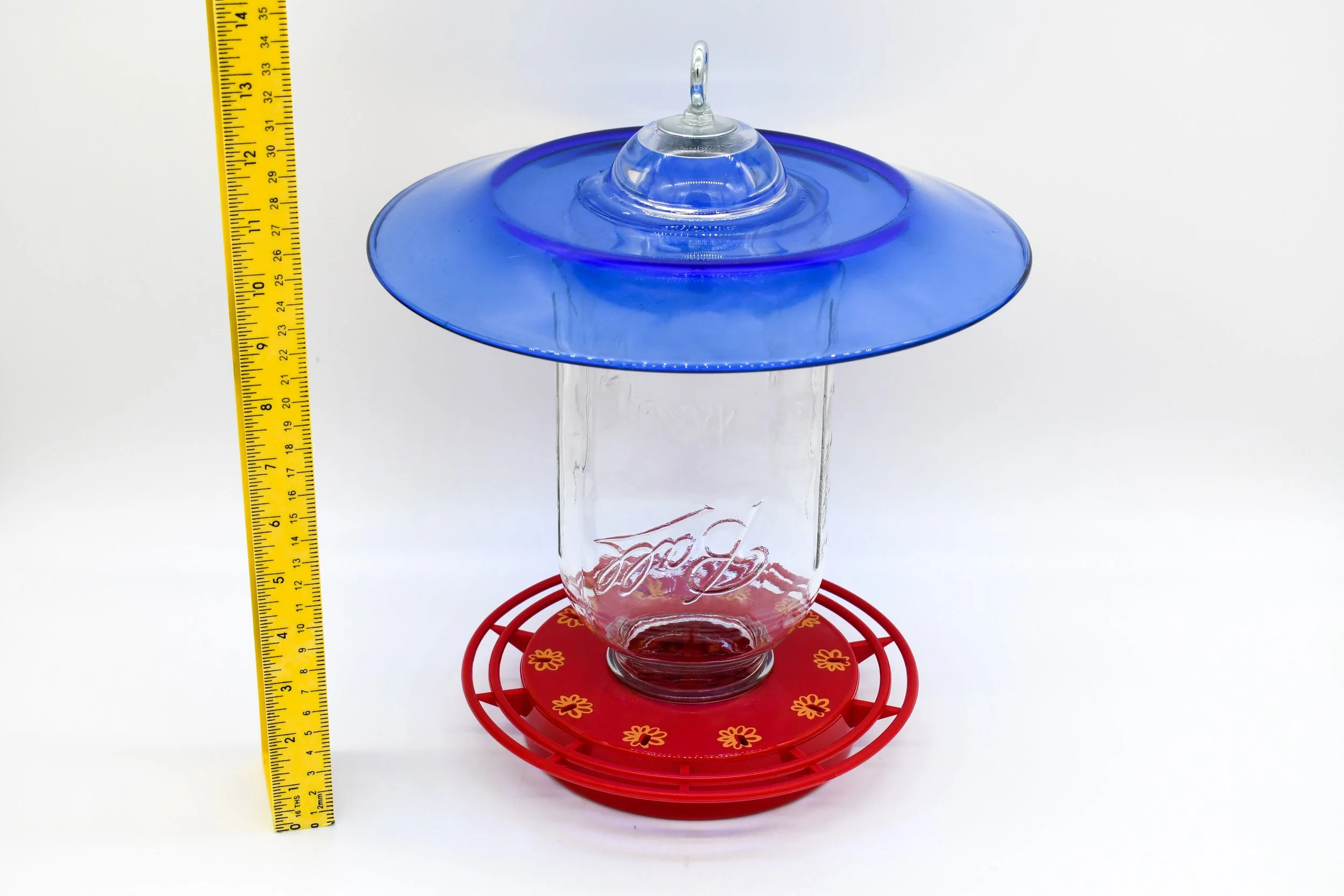 Angled view of the jumbo Mason jar feeder with cobalt blue glass and 10-station feeding base.