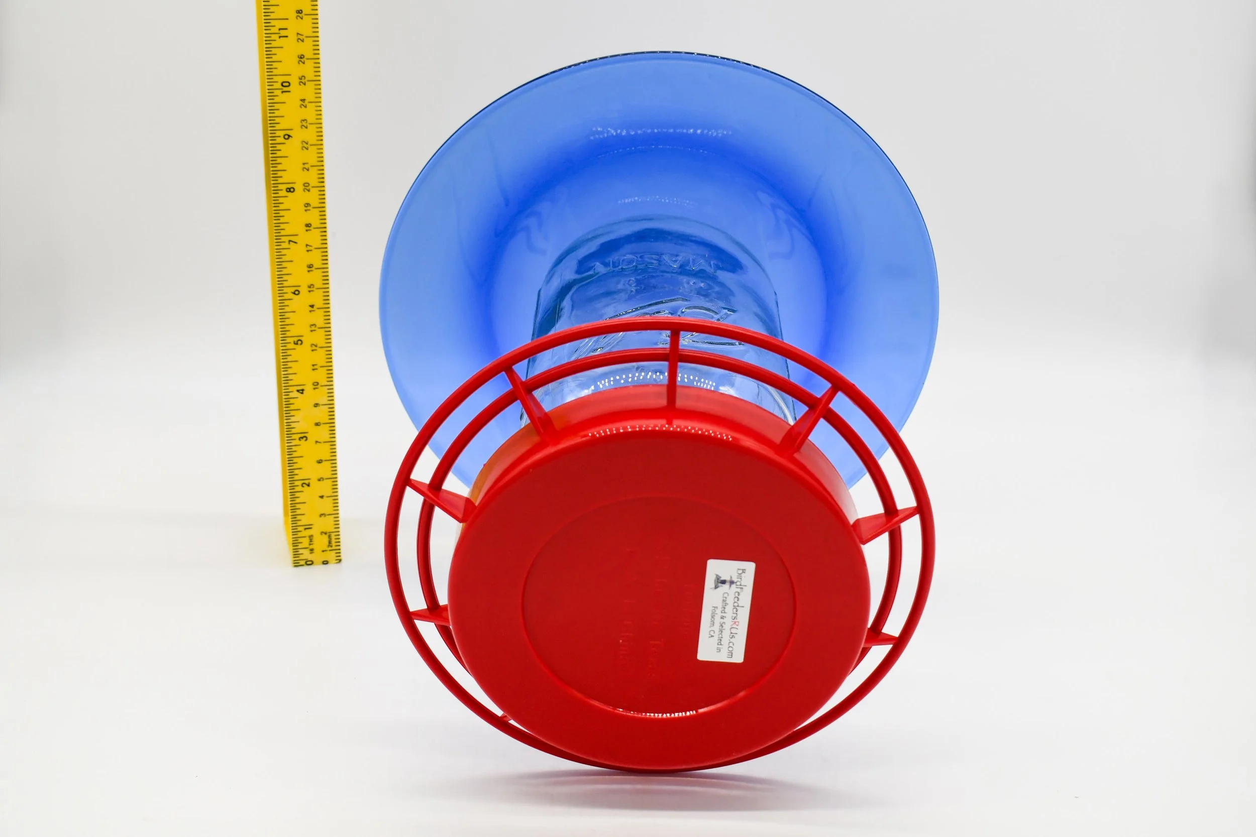 Underside view showing the cobalt glass plate, Mason jar reservoir, and circular red perches.