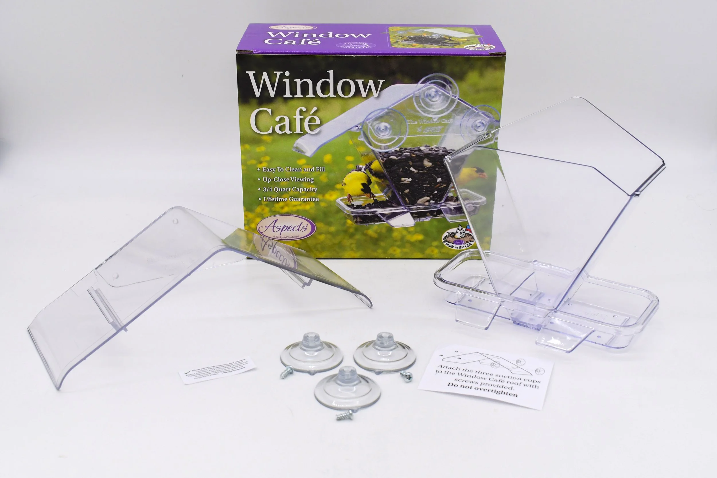 Aspects #155 Window Cafe bird feeder with retail packaging, suction cups, clear polycarbonate components, and assembly instructions displayed.