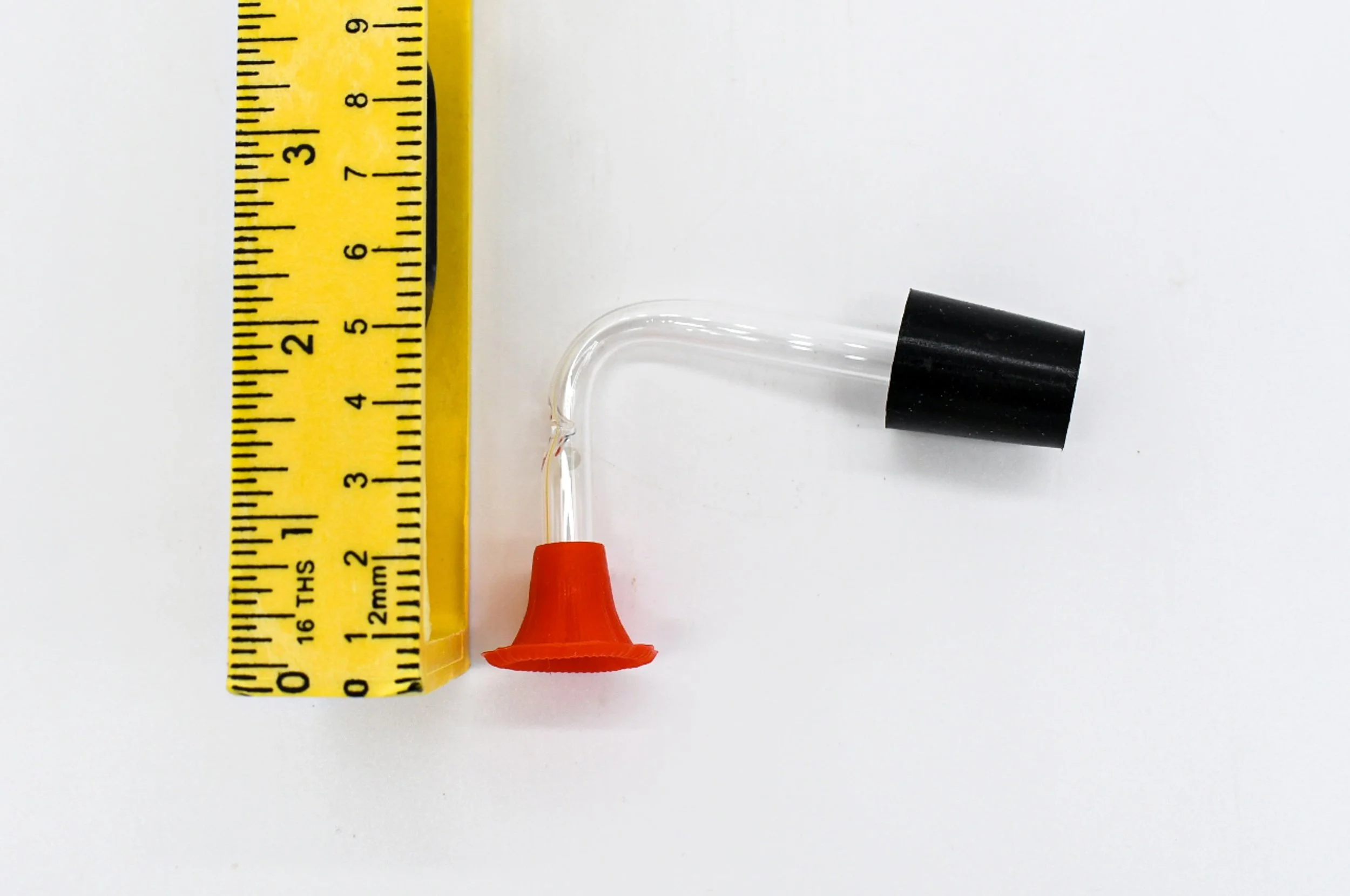 Songbird Essentials hummingbird feeder stopper and clear tube shown with ruler for size reference