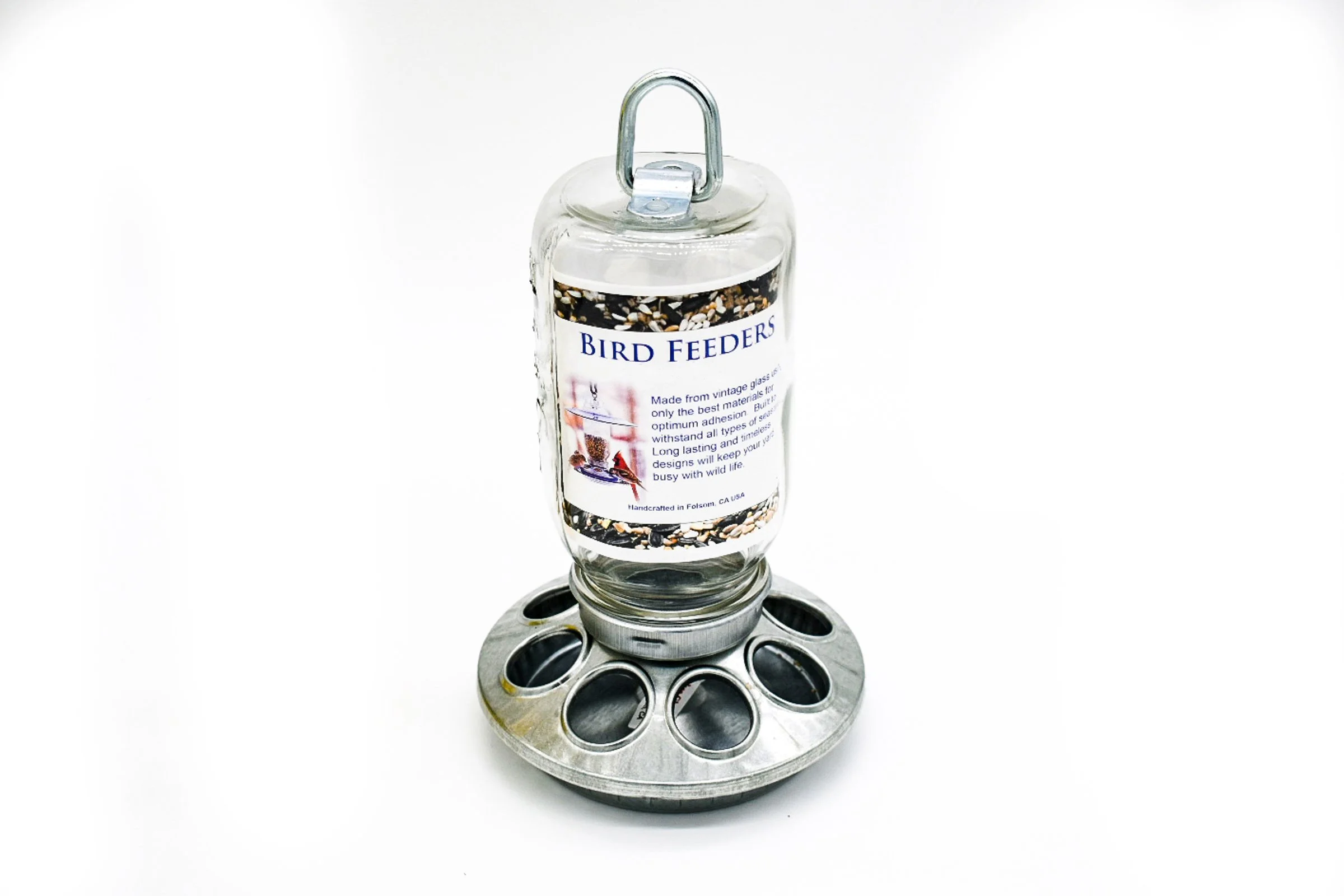 Back view of handmade Mason jar hanging bird feeder showing BirdFeedersRus product label and clear glass jar