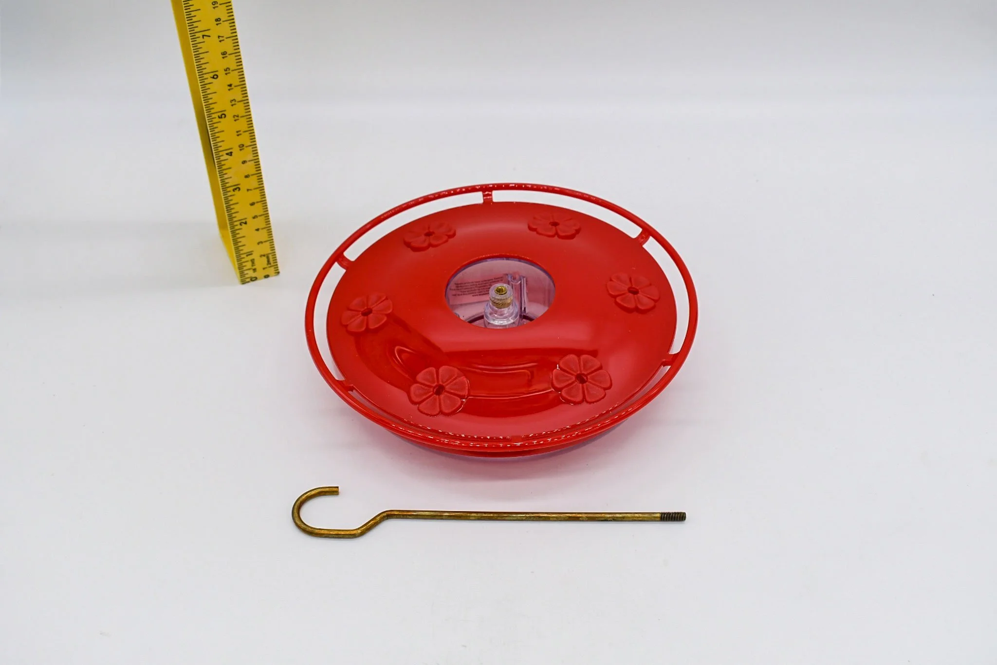 Angled view of the assembled Aspects HighView Excel feeder with hanging hook and measuring tape for scale.