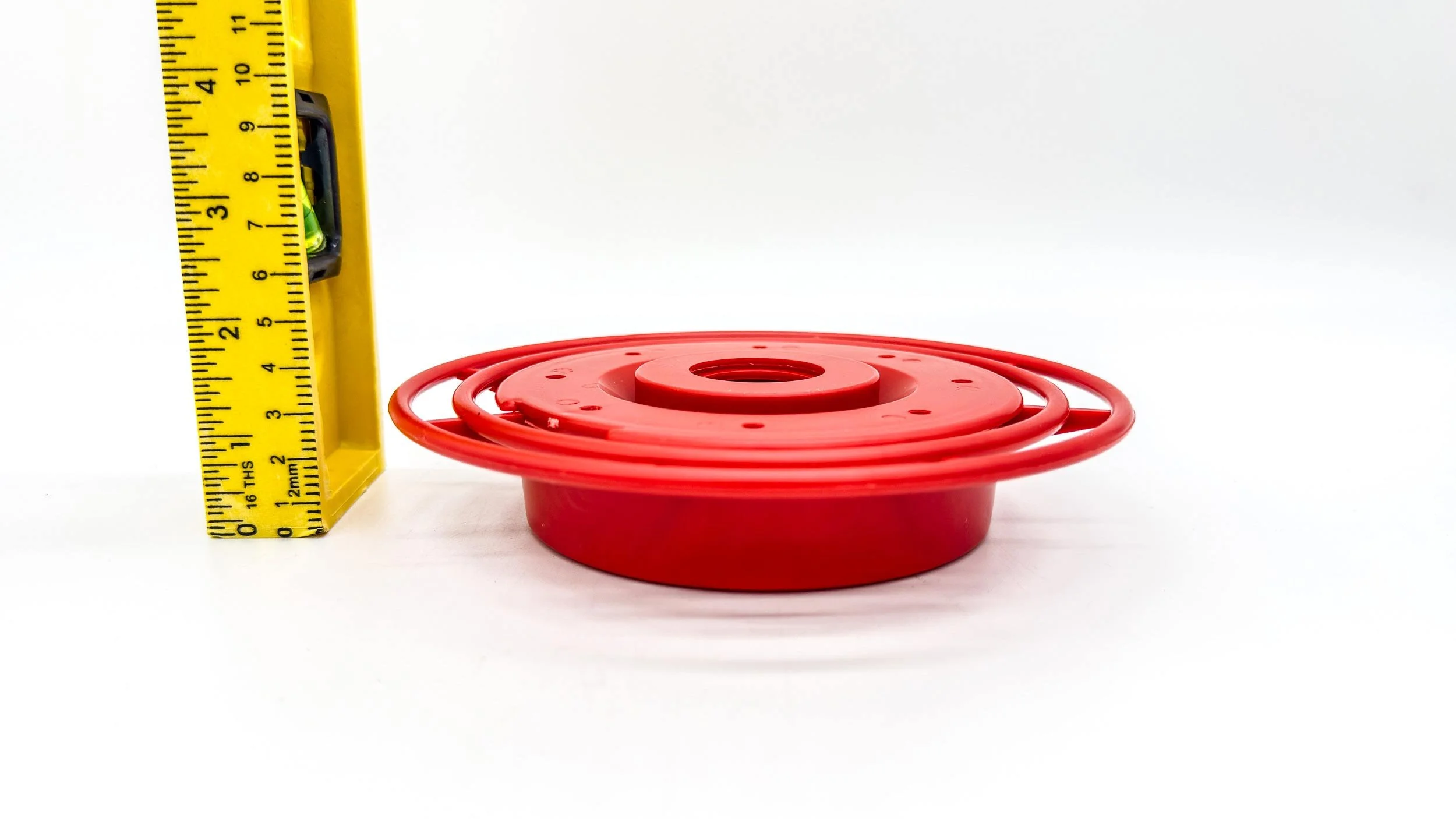 side photo of best1 feeder base with ruler showing height