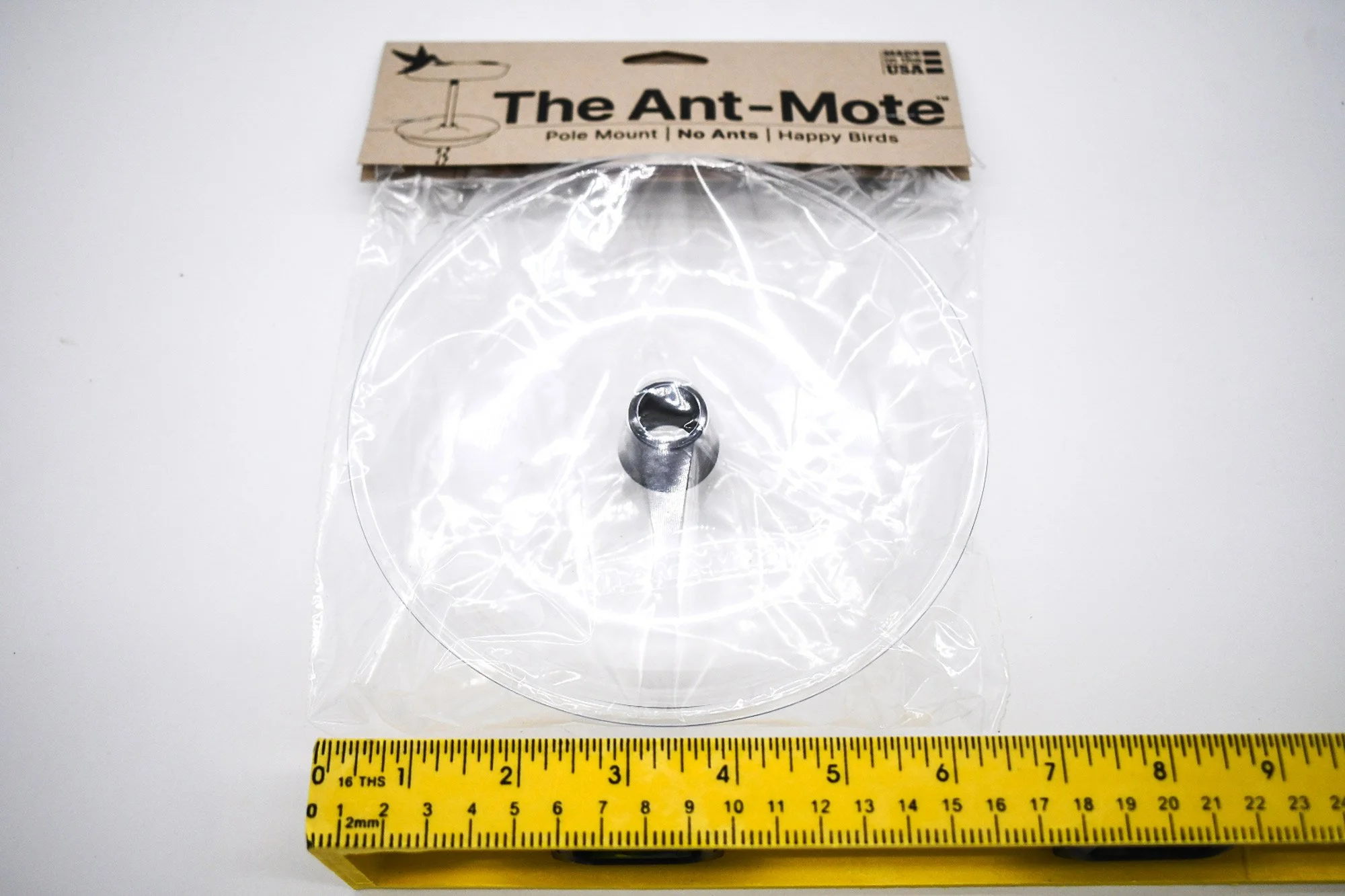Clear Ant Mote™ shown in original packaging with ruler for product size and measurement reference.