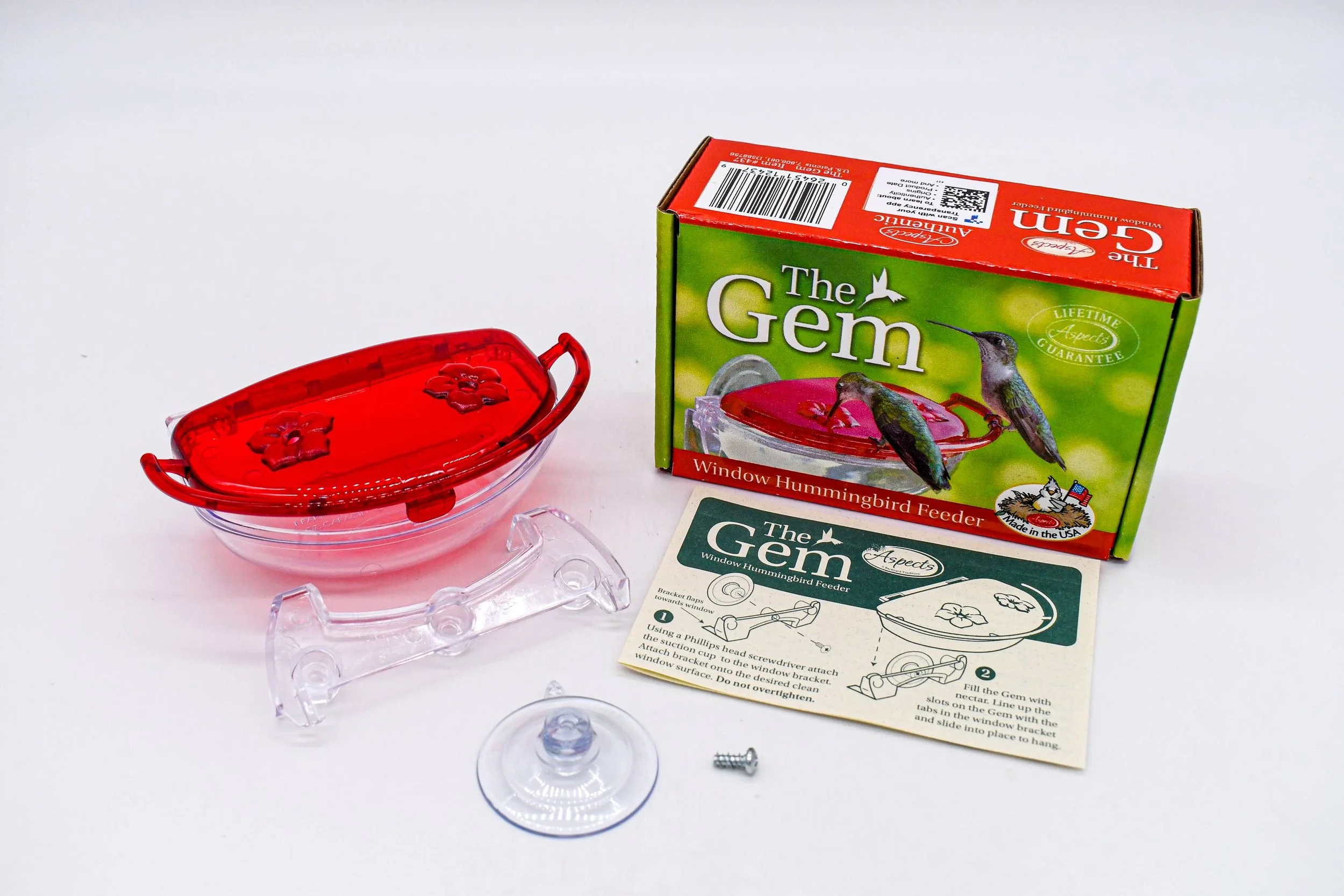 Complete Aspects The Gem 4 oz Window Hummingbird Feeder kit including feeder, mounting bracket, suction cup, hardware, instructions, and retail packaging.