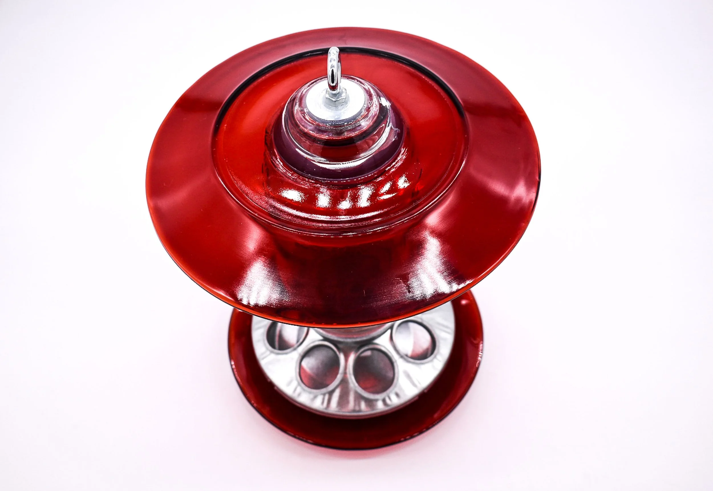 Top view of handmade red glass bird feeder showing the wide vintage glass rain guard, hanging hardware and feeding tray.