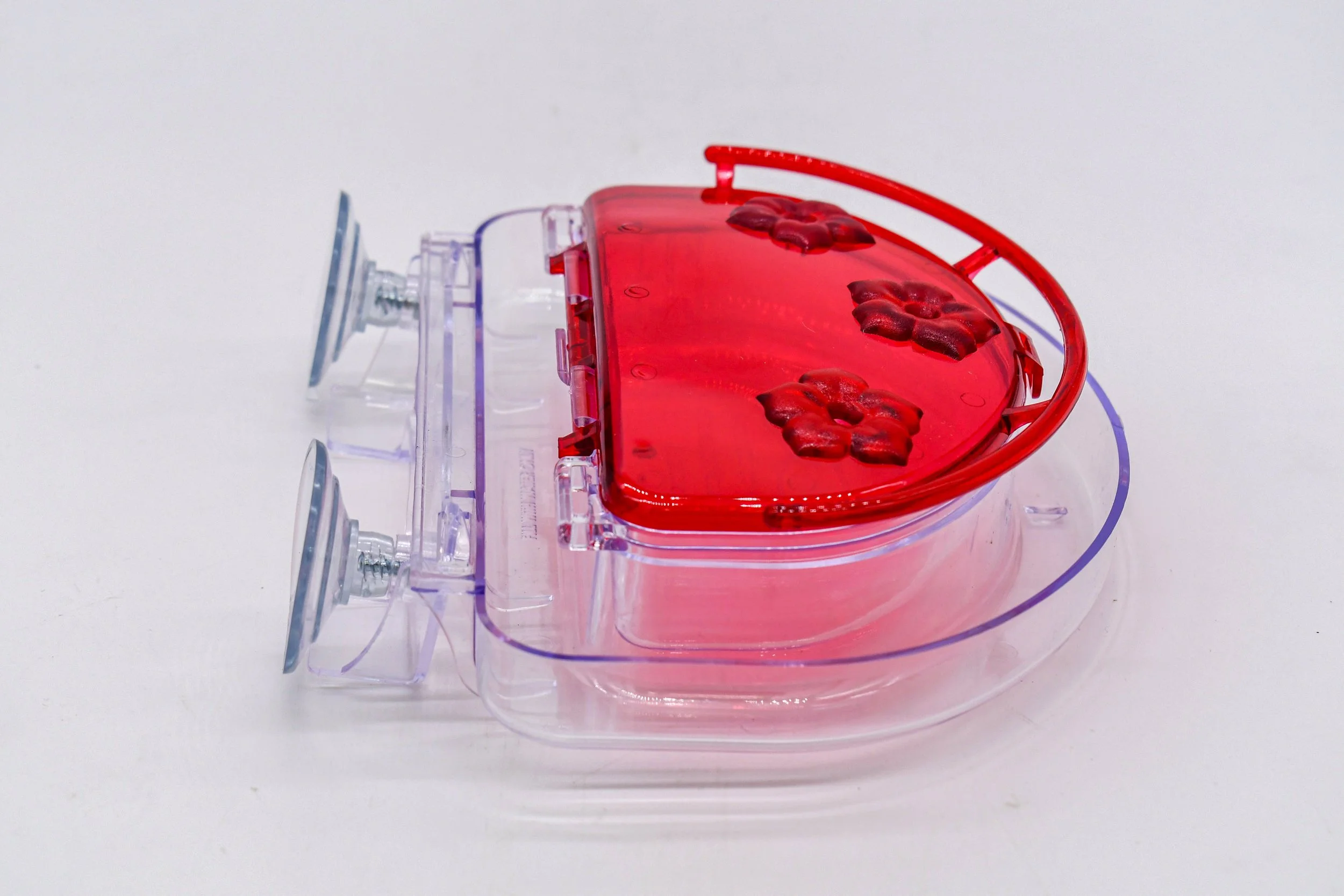 Side view of Aspects 407 Jewel Box hummingbird feeder with hinged red cover open and clear nectar reservoir