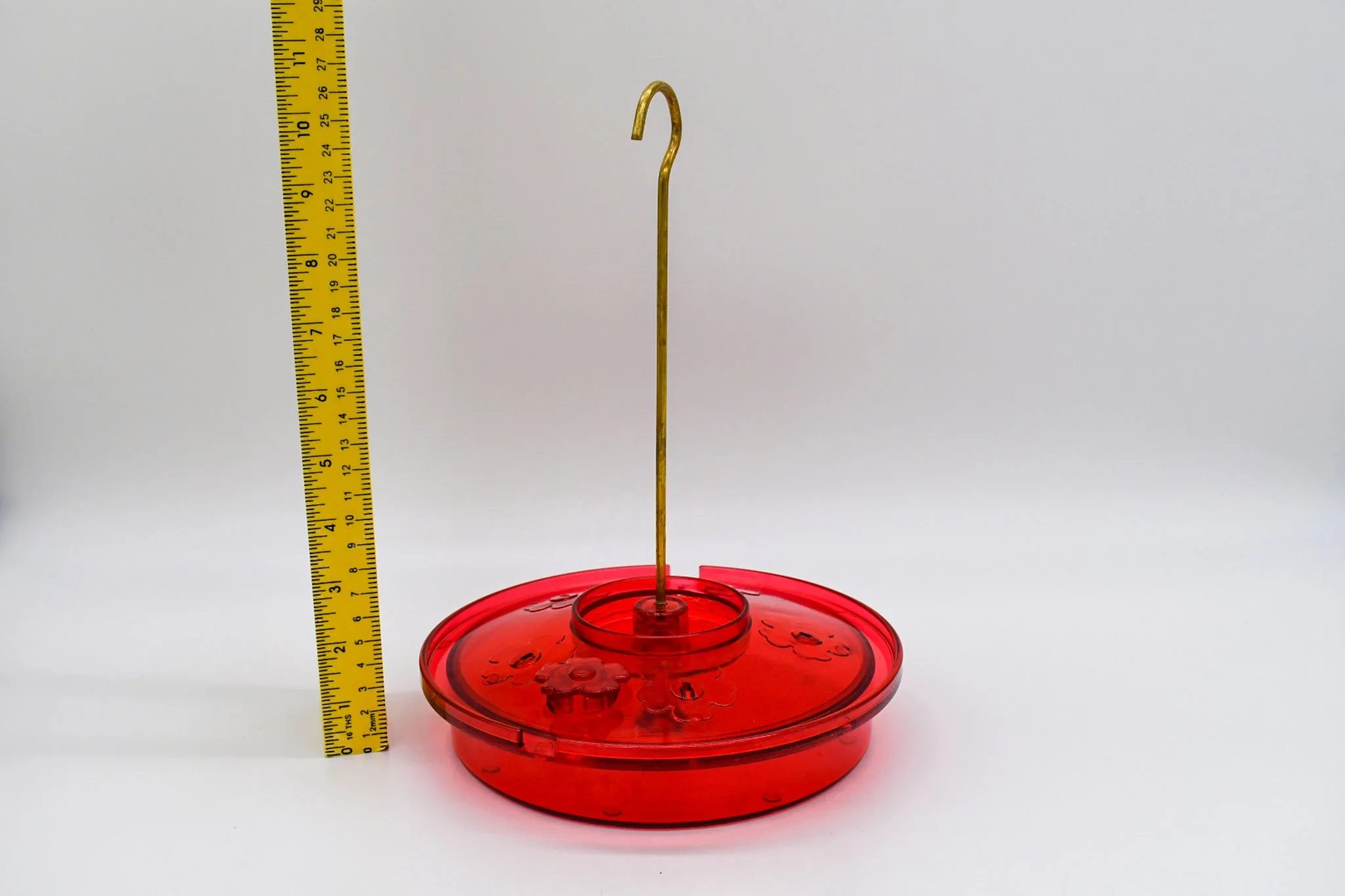 Assembled Hummingbird Haven feeder beside a ruler showing its height and included metal hanging hook.