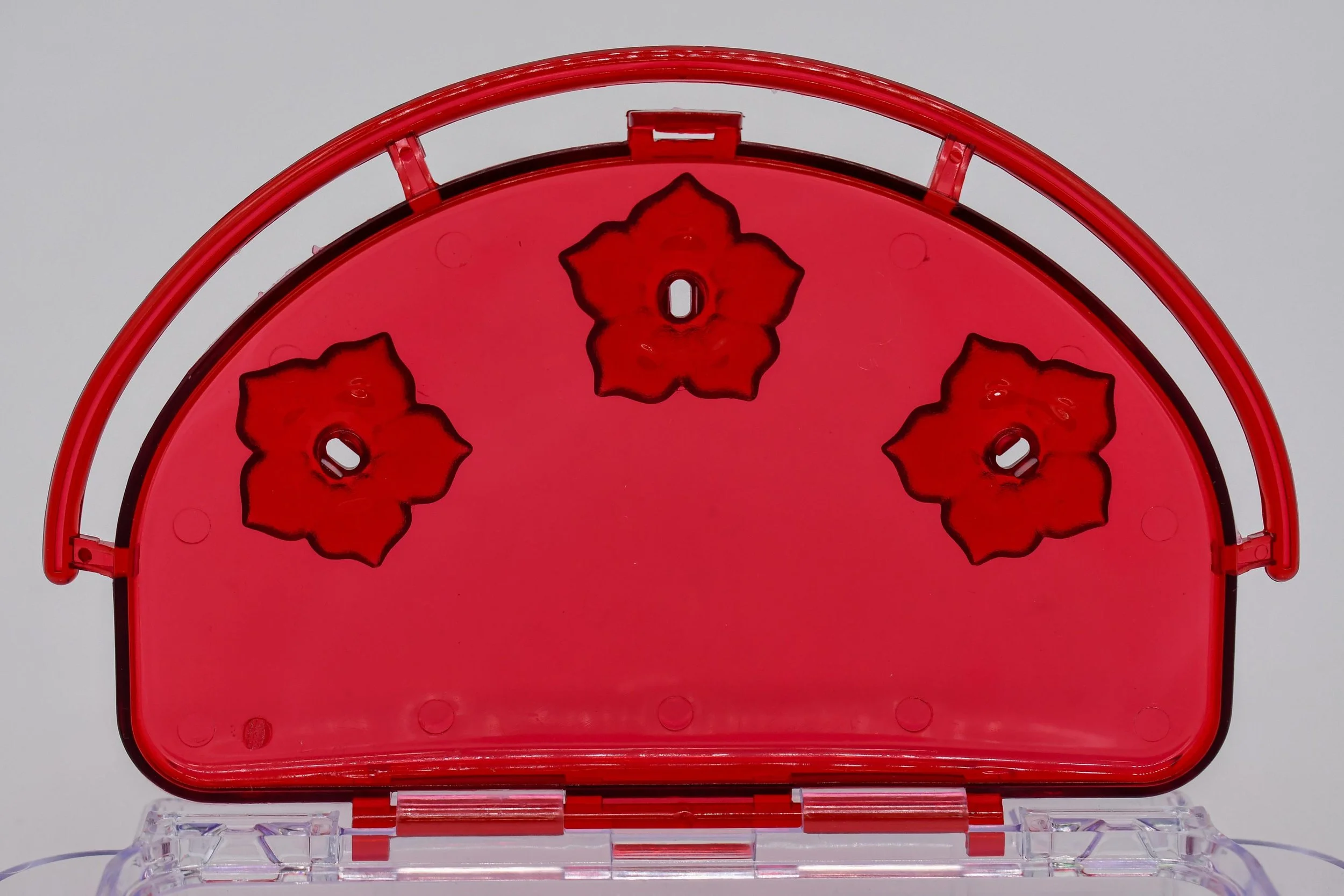 Close-up of Aspects 407 Jewel Box hummingbird feeder showing three flower-shaped feeding ports and HighView perch