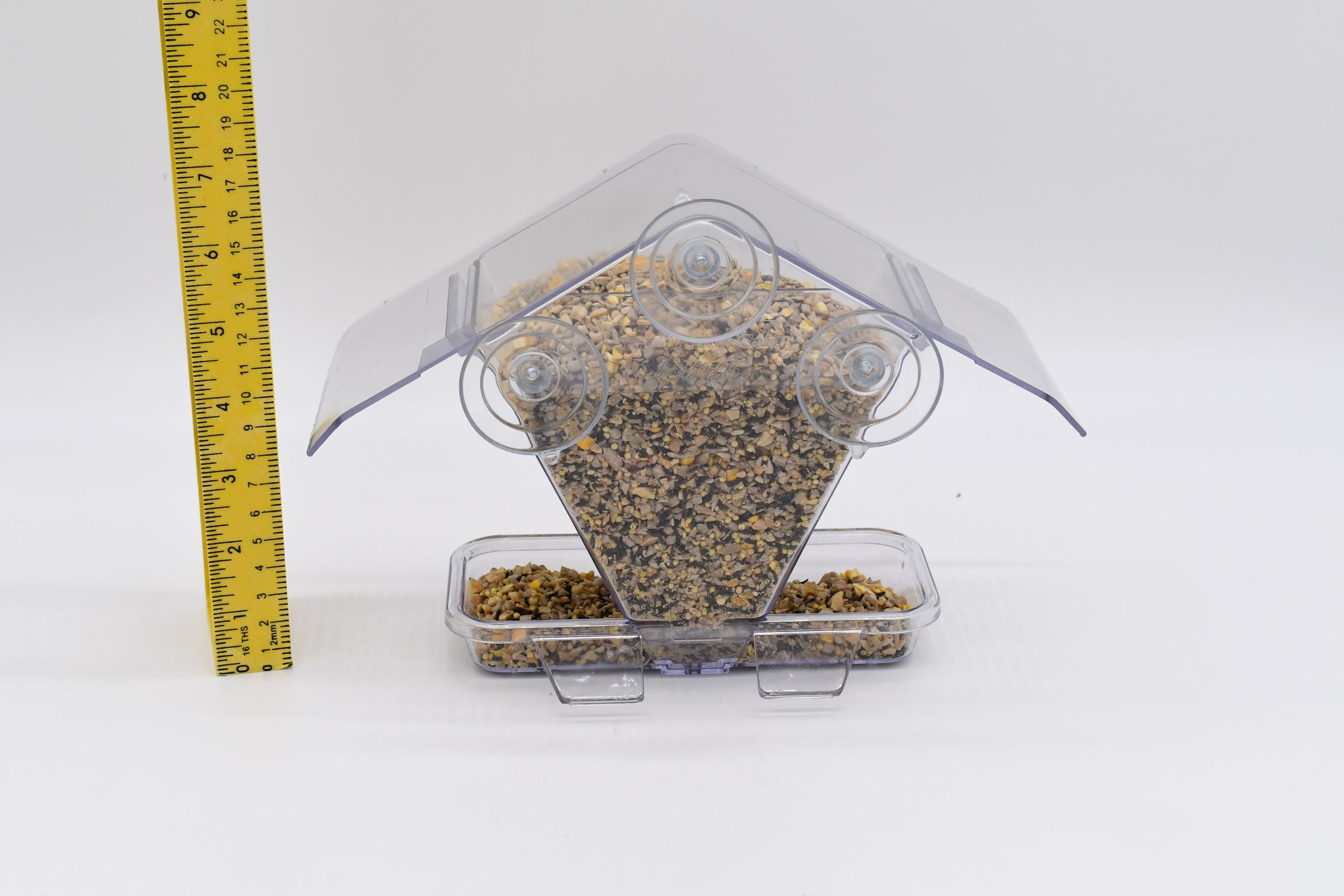 Rear view of the Aspects #155 Window Cafe filled with birdseed, showing three suction cups for mounting directly to window glass.