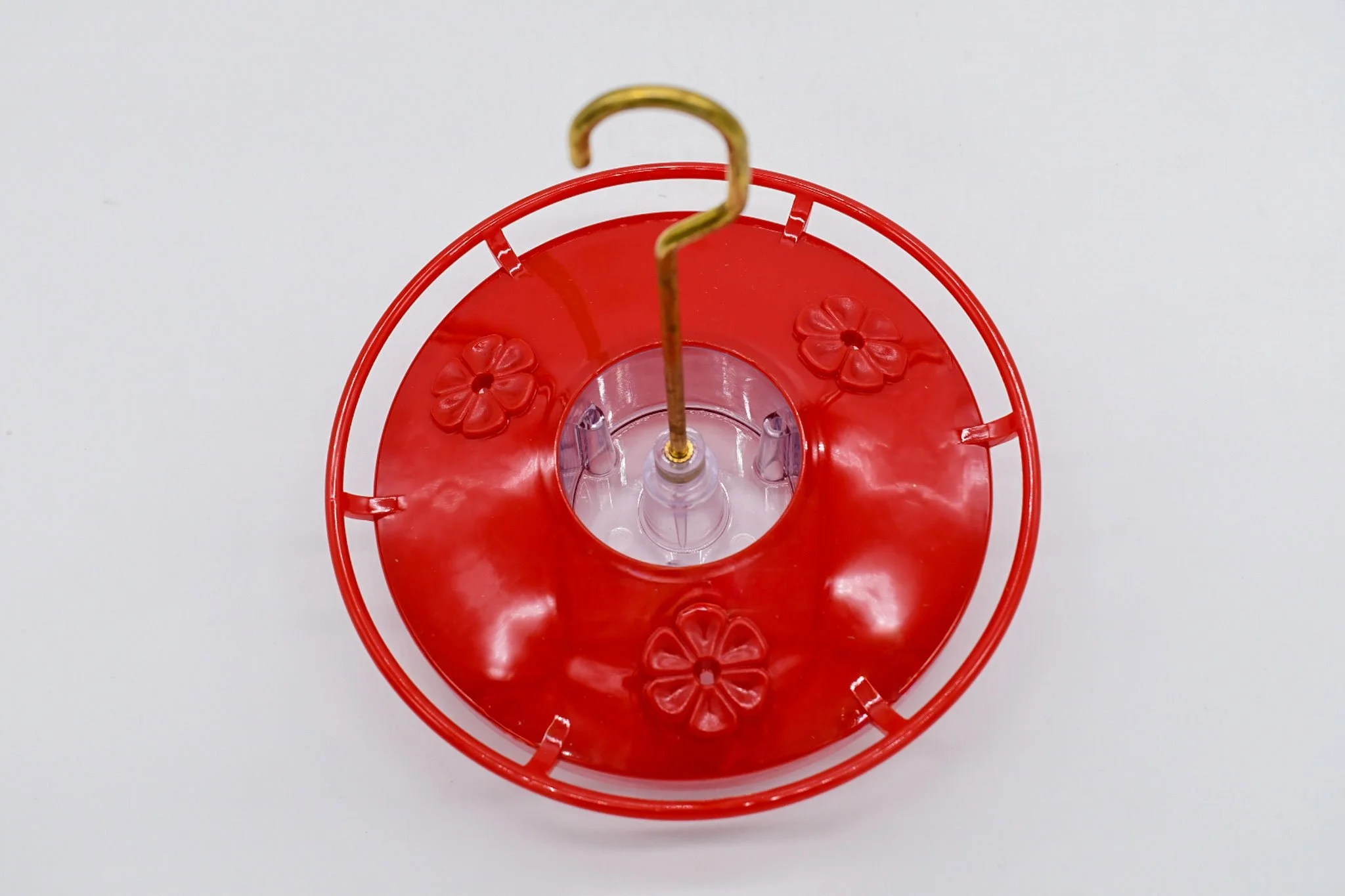 Top view of the Aspects HighView Mini hummingbird feeder with bright red cover and three feeding flowers.