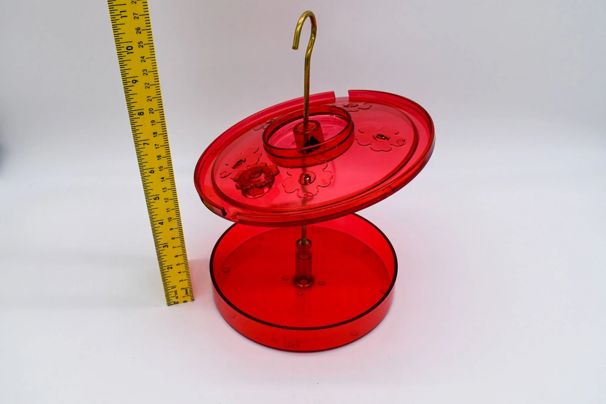 Side view of the Hummingbird Haven feeder with its red cover raised for easy cleaning.