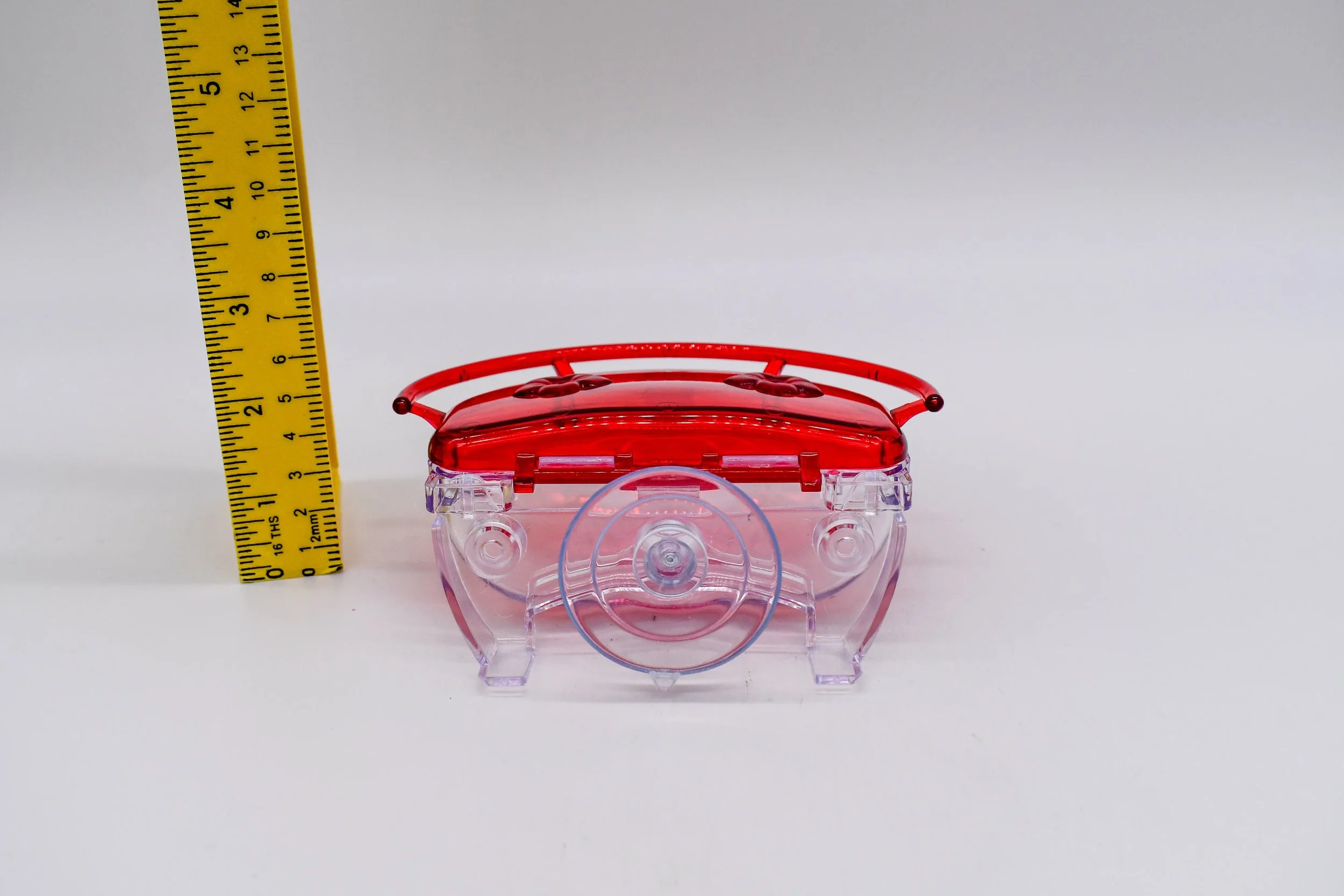 Front view of the Aspects The Gem 4 oz Window Hummingbird Feeder with measuring tape showing overall height and compact window-mounted design.