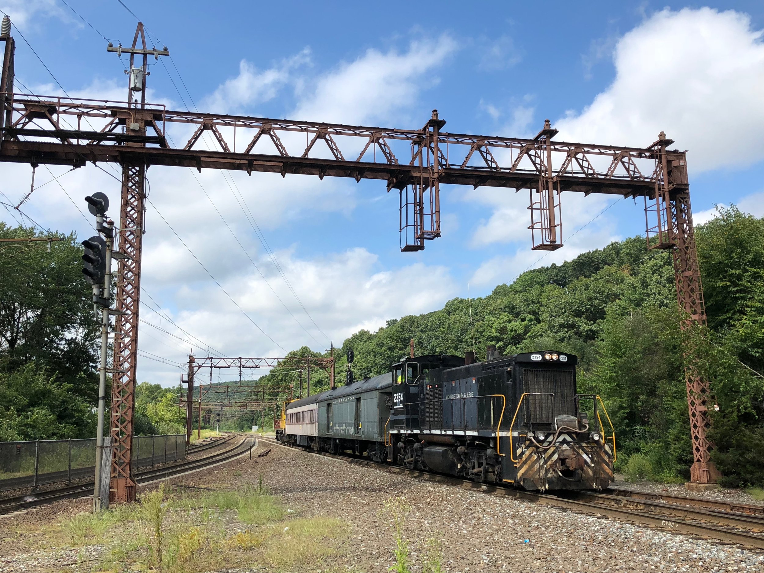  The consist rolls east through Denville, being shoved by M&amp;E 20. 