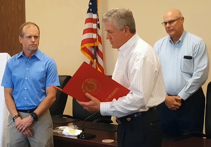 In this March 20, 2017 photo, on behalf of State Sen. Brandon Creighton, R-Conroe, County Judge Craig Doyal, center, reads Senate Resolution No. 425, honoring Richard J. Tramm, left, for his service to the Lone Star Groundwater Conservation District during a recognition reception held at LSGCD’s office in Conroe. Standing to the right is newly elected LSGCD Board President Rick Moffatt.