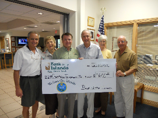 Al Hanser delivers his donation to the Charitable Foundation of the Islands. 