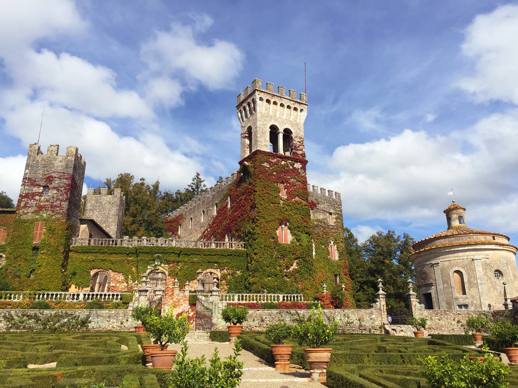 A stunning ivy-covered castle and its gardens in Italy