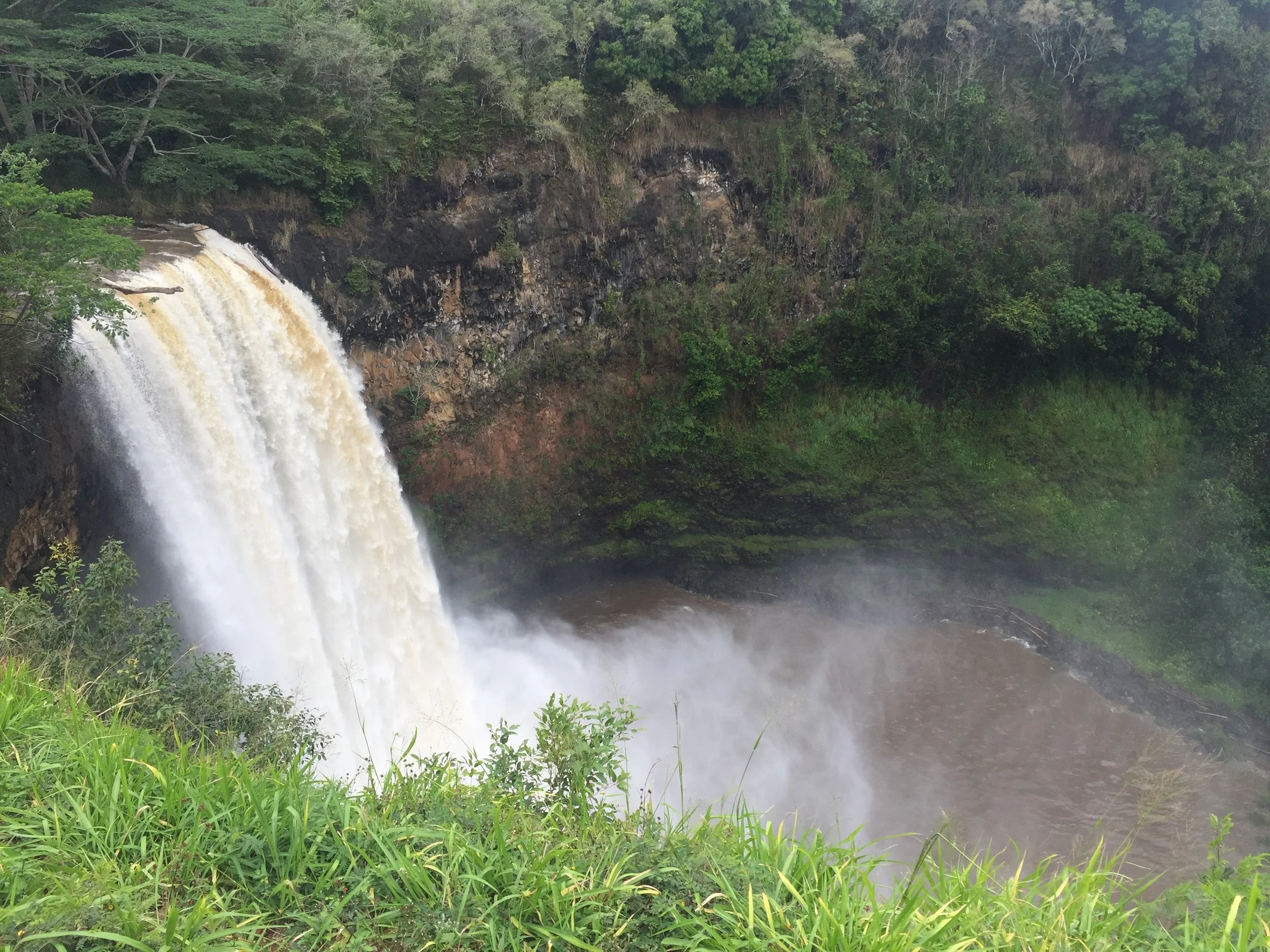 This is Wailua Falls! Its HUGE.&nbsp;It was raining pretty hard this day. We drove up, got out, took some photos and then got back in the car. There were flash flood warnings so we couldn't hike down.&nbsp;