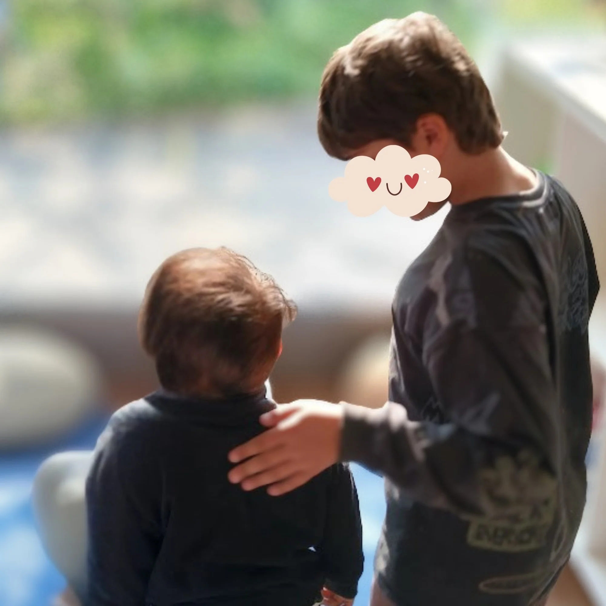 Older SISOG student shares a learninig moment with a student from the creche.