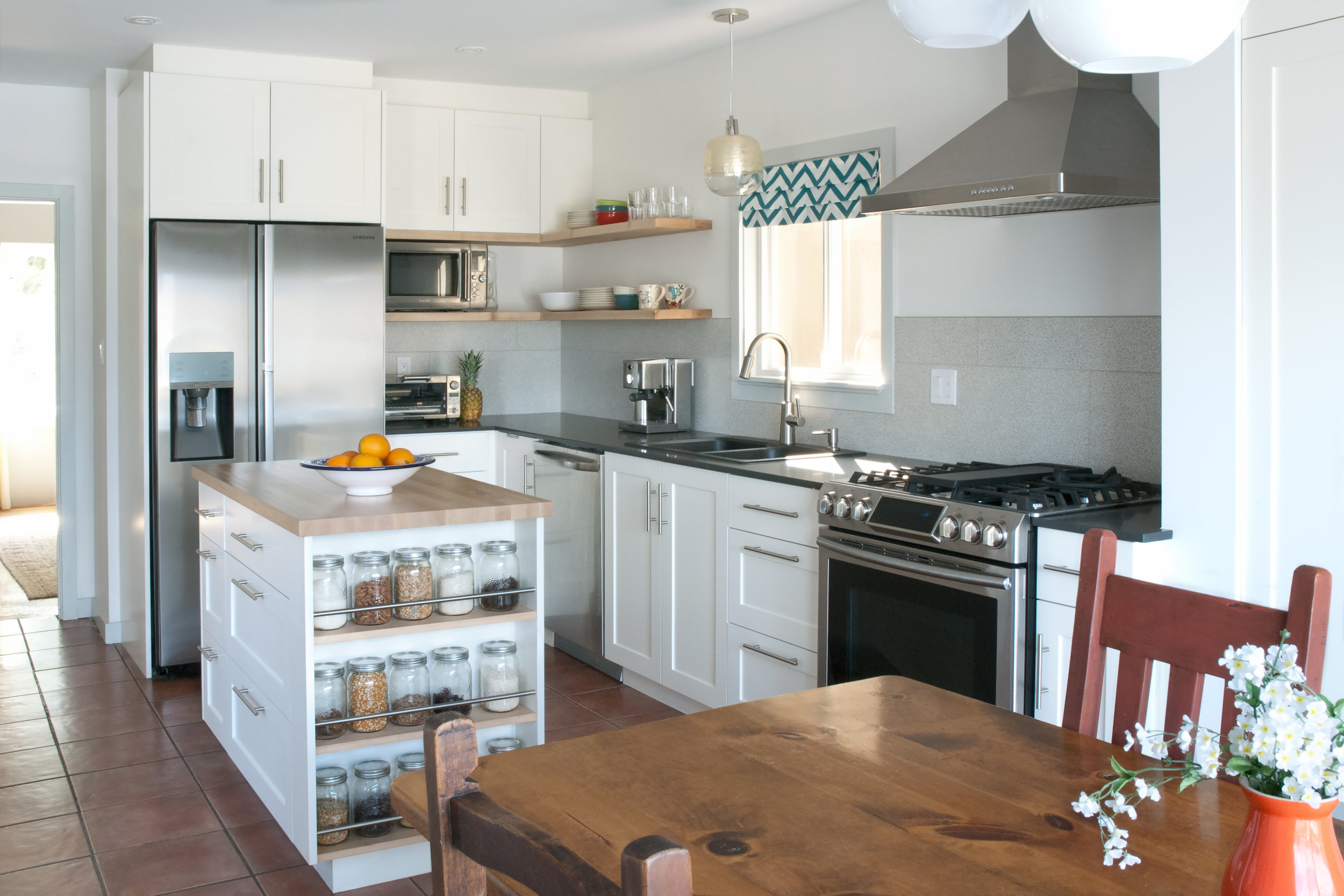 This project involved a complete kitchen rehab for a family who had just moved into this charming character house in East Vancouver. Due to budgetary constraints, we chose to save the existing terracotta tile in the room, but completely reconfigured
