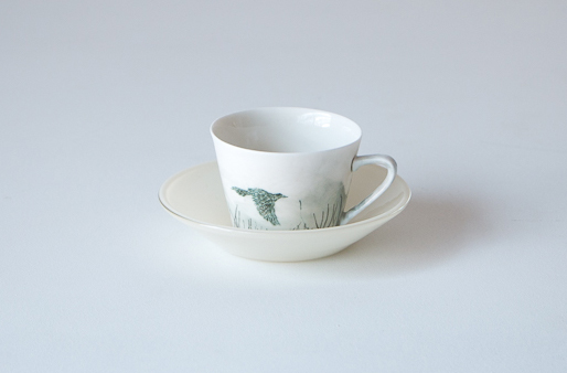 cup and saucer with wattlebird