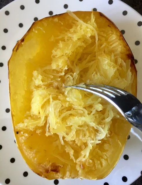 TIP: The longer the spaghetti squash is cooked, the easier it detaches from the skin, making you less likely to tear the 'boat'! 