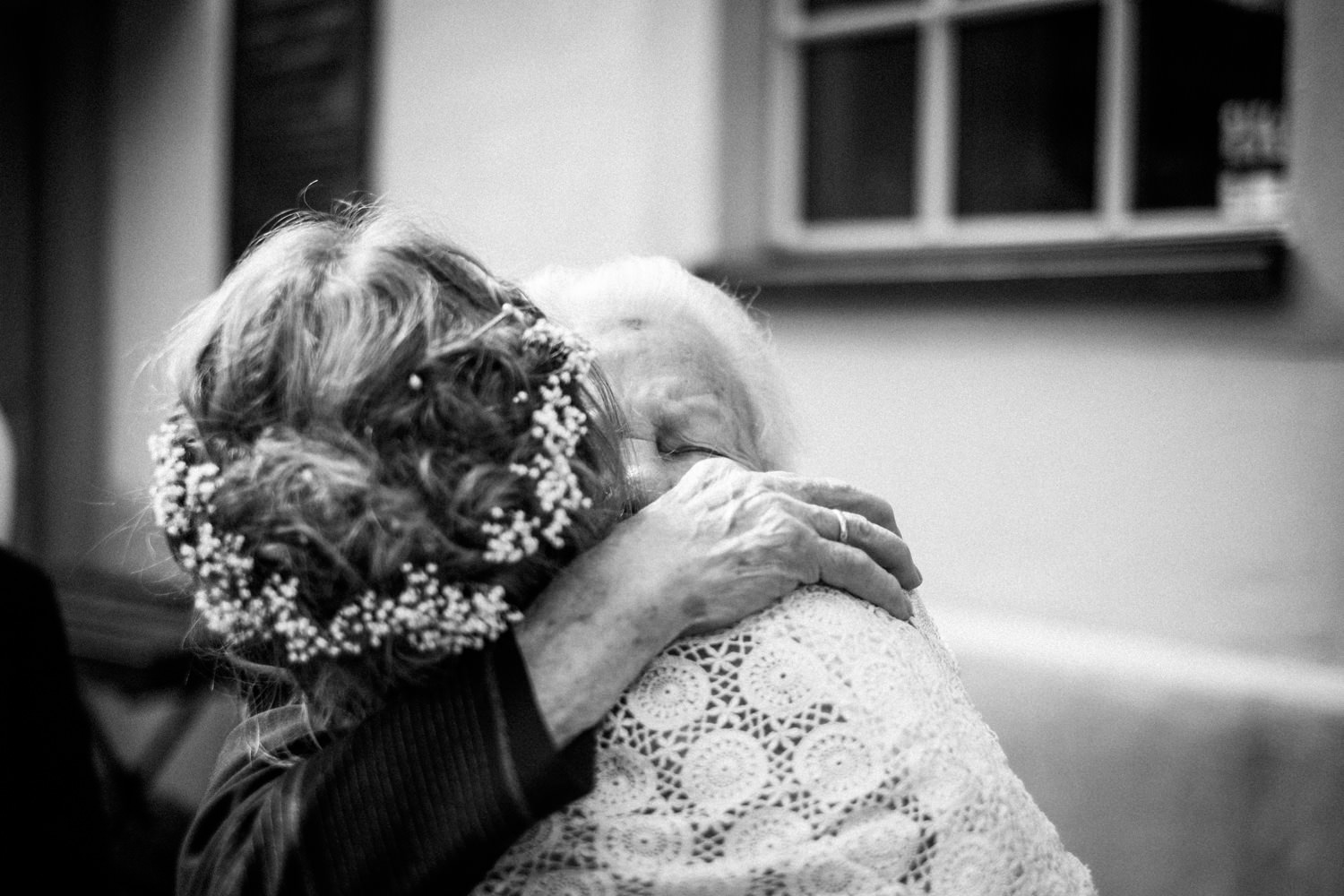Gerührte Oma umarmt Braut in Burbach nach Zeremonie