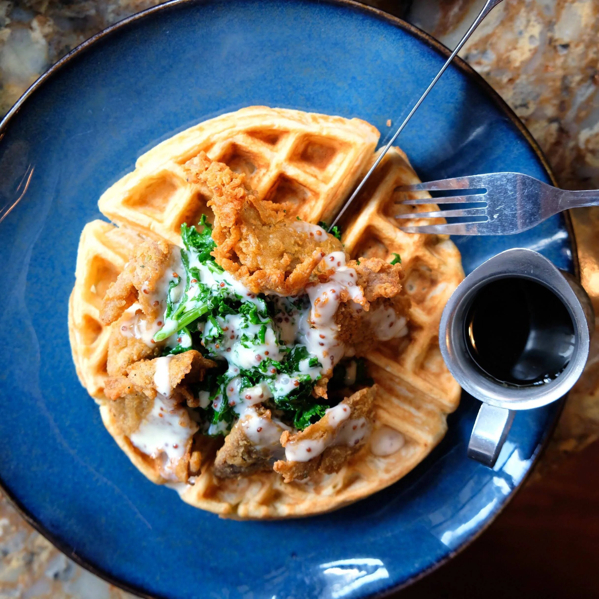 chick-un & waffles ($22) southern fried seitan, sautéed garlic kale, crispy belgian wa√e, maple mustard aioli o