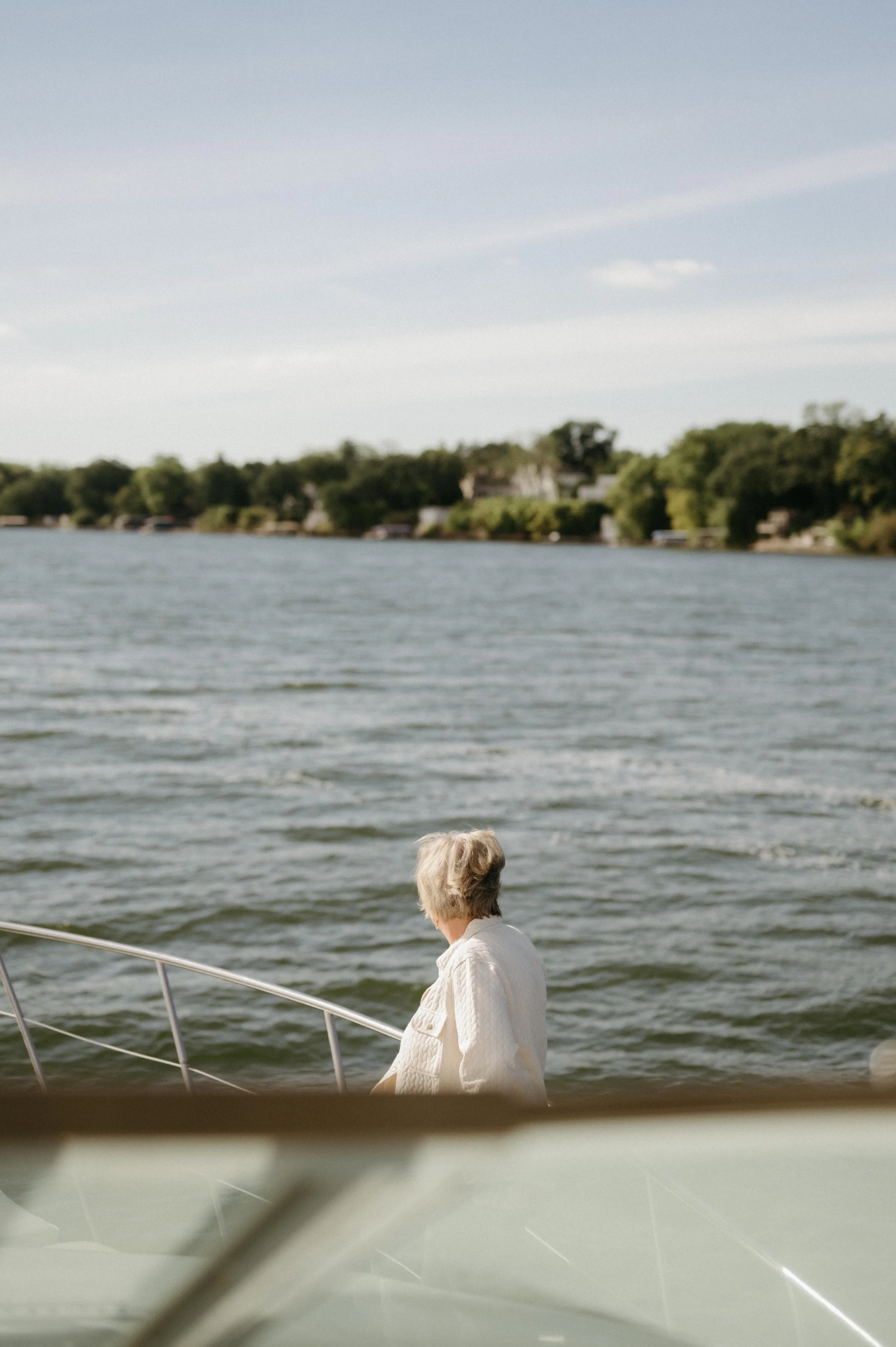 View of Lake Mendota during a wedding weekend welcome dinner cruise in Madison, Wisconsin. Moody Madison wedding photographer. Documentary wedding photographer.