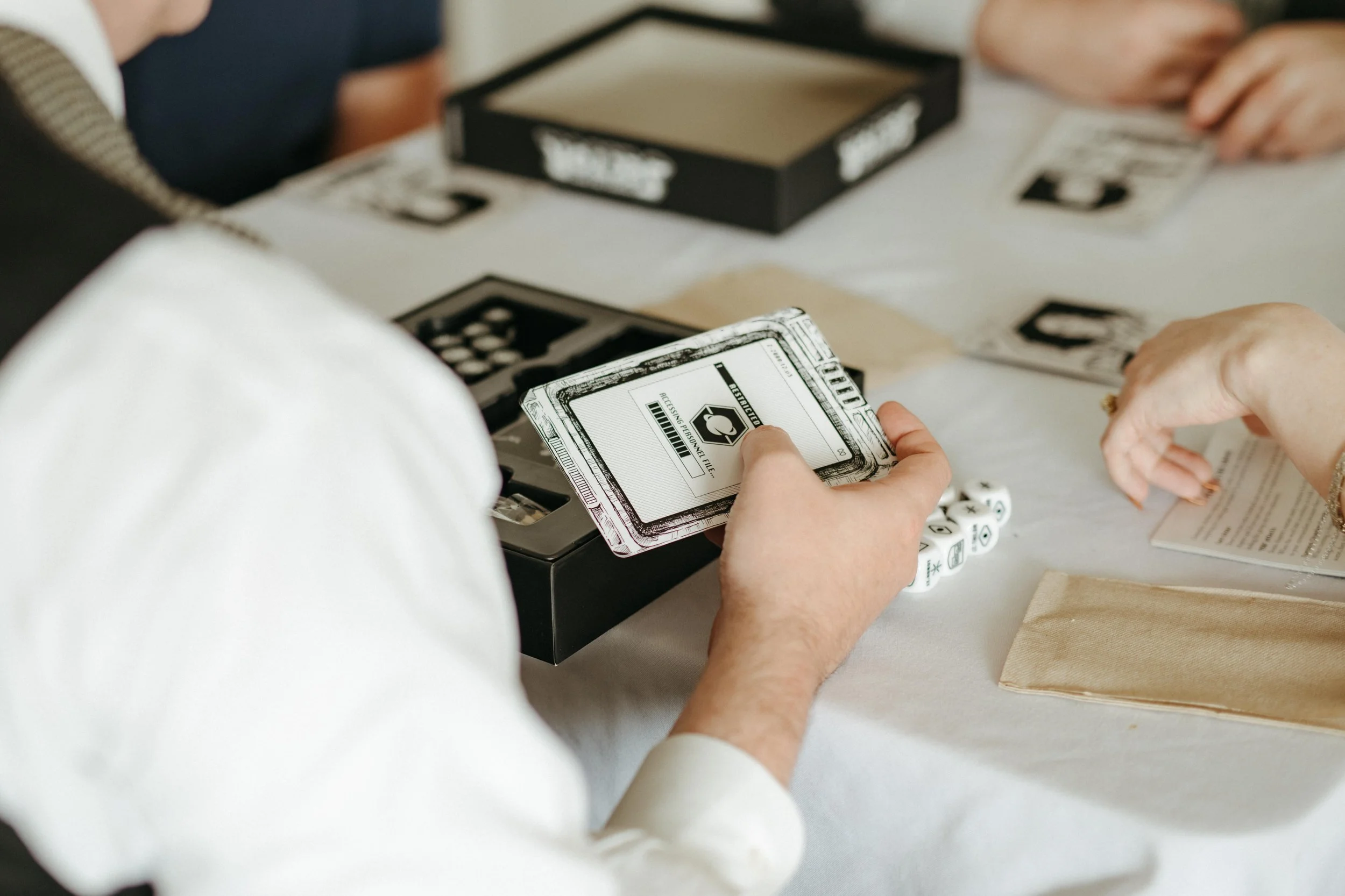 Moody Memphis wedding photographer a bride and groom play a board game at their wedding reception. Documentary Memphis Wedding Photographer. Cinematic Memphis wedding photographer.