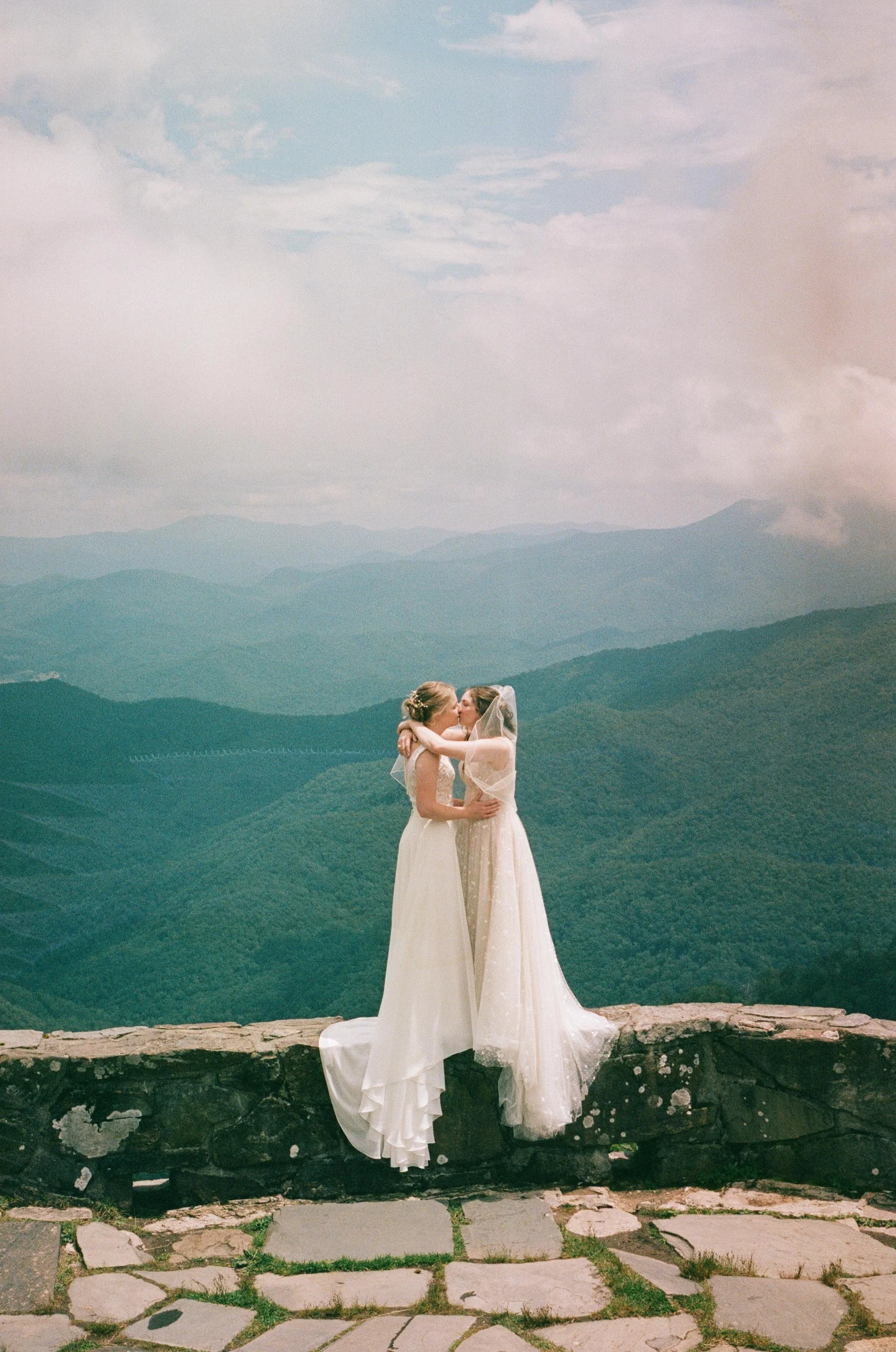 Film wedding photographer two brides kiss on a mountaintop in Nantahala, North Carolina on 35 mm film. Memphis film wedding photographer. North Carolina film wedding photographer. Memphis Documentary wedding photographer.