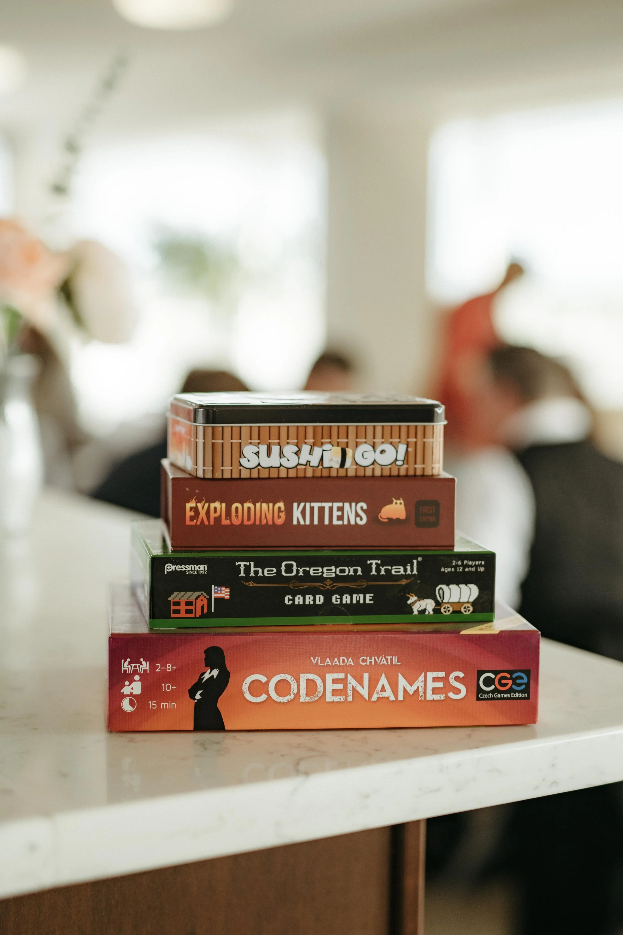 Moody Memphis wedding photographer wedding guests play a board game at a wedding reception. Documentary Memphis Wedding Photographer. Cinematic Memphis wedding photographer.