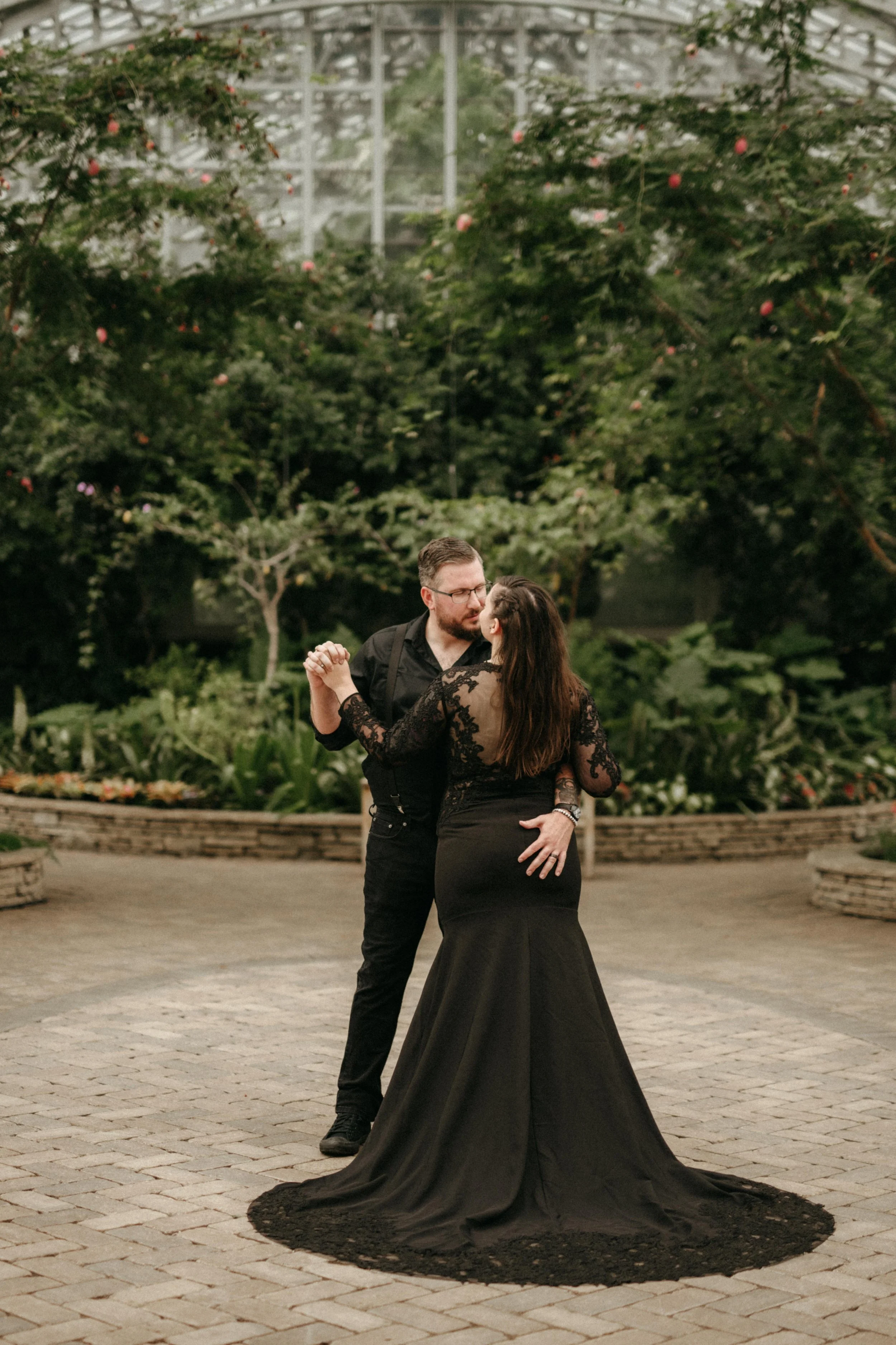Back view of an all black wedding dress with long black lace sleeves and an open lace back.